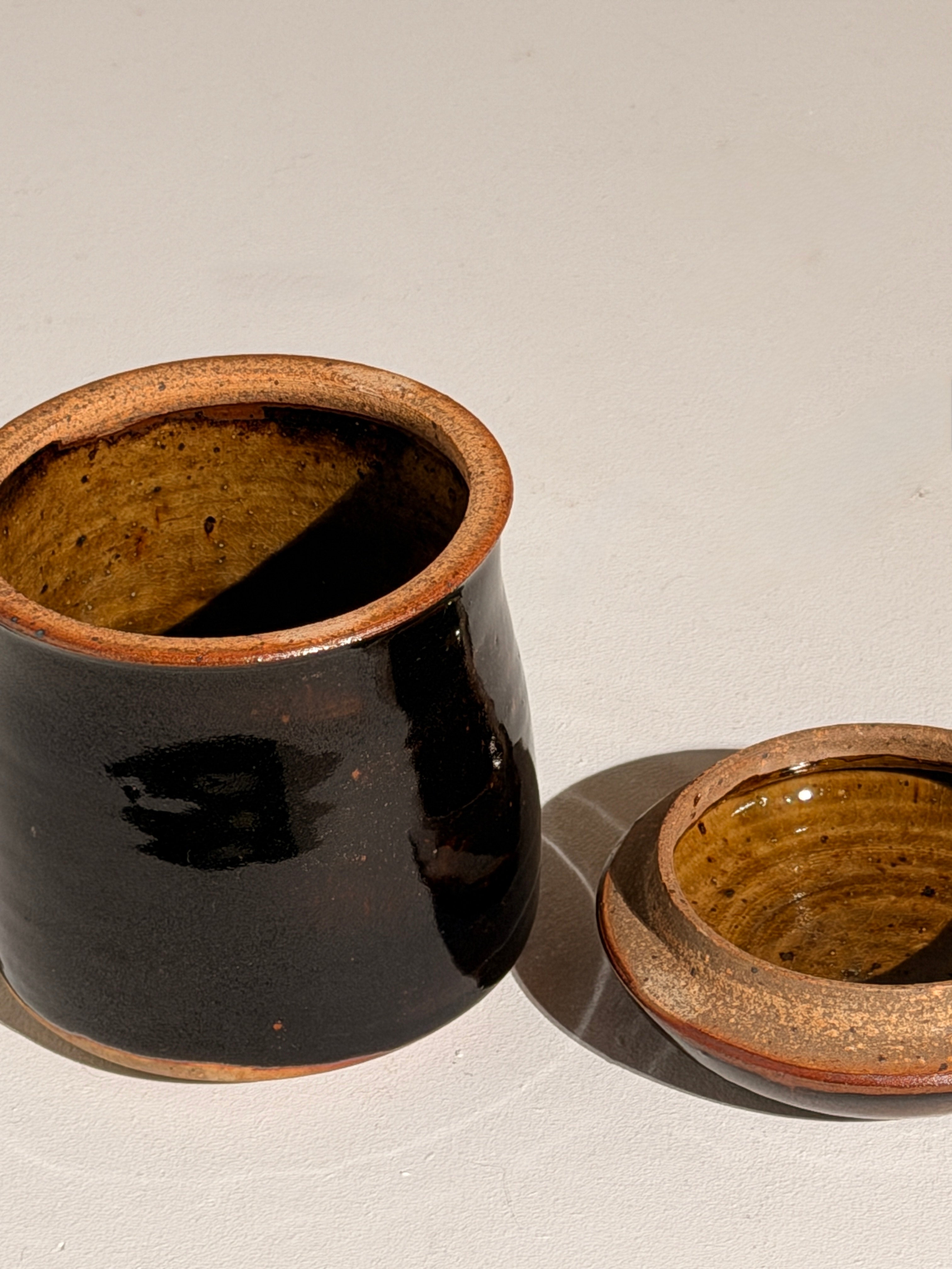 Lidded Stoneware Pot, France, circa 1960–1970 — angled view showing dark glaze and interior