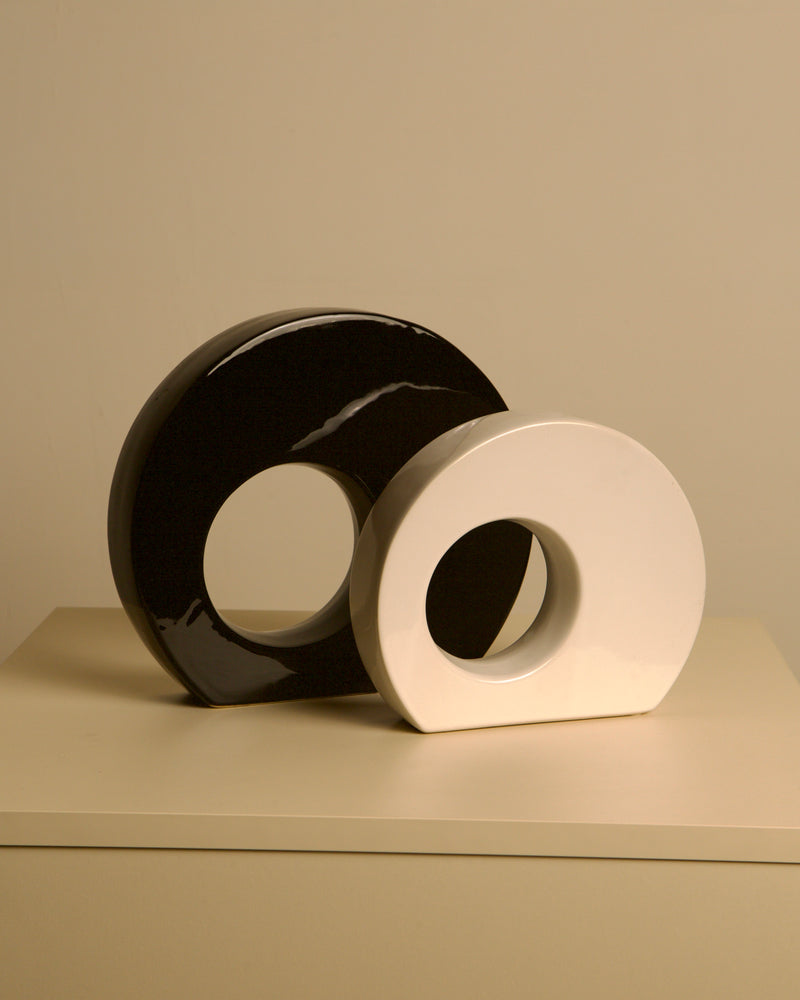 Pair of black and white ceramic vases by Sicart 80's — close-up of glossy surfaces on neutral background