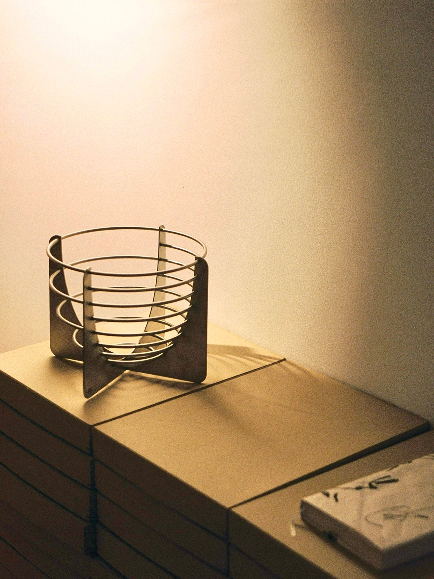 Draft Bowl — side angle on stacked boxes with warm lighting