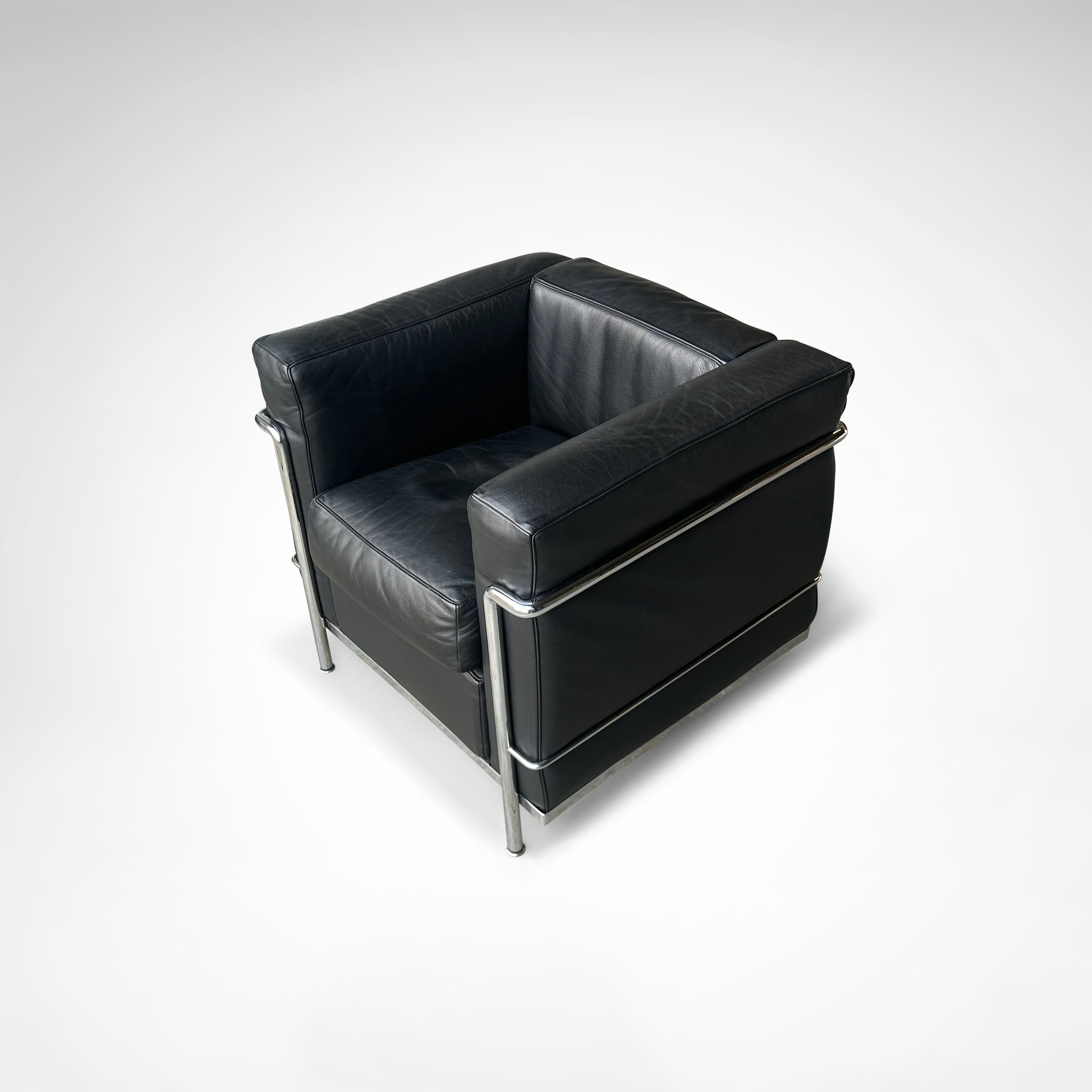 LC2 Armchair and Ottoman by Le Corbusier et al. for Cassina 1990s — close-up of black leather upholstery and chrome frame