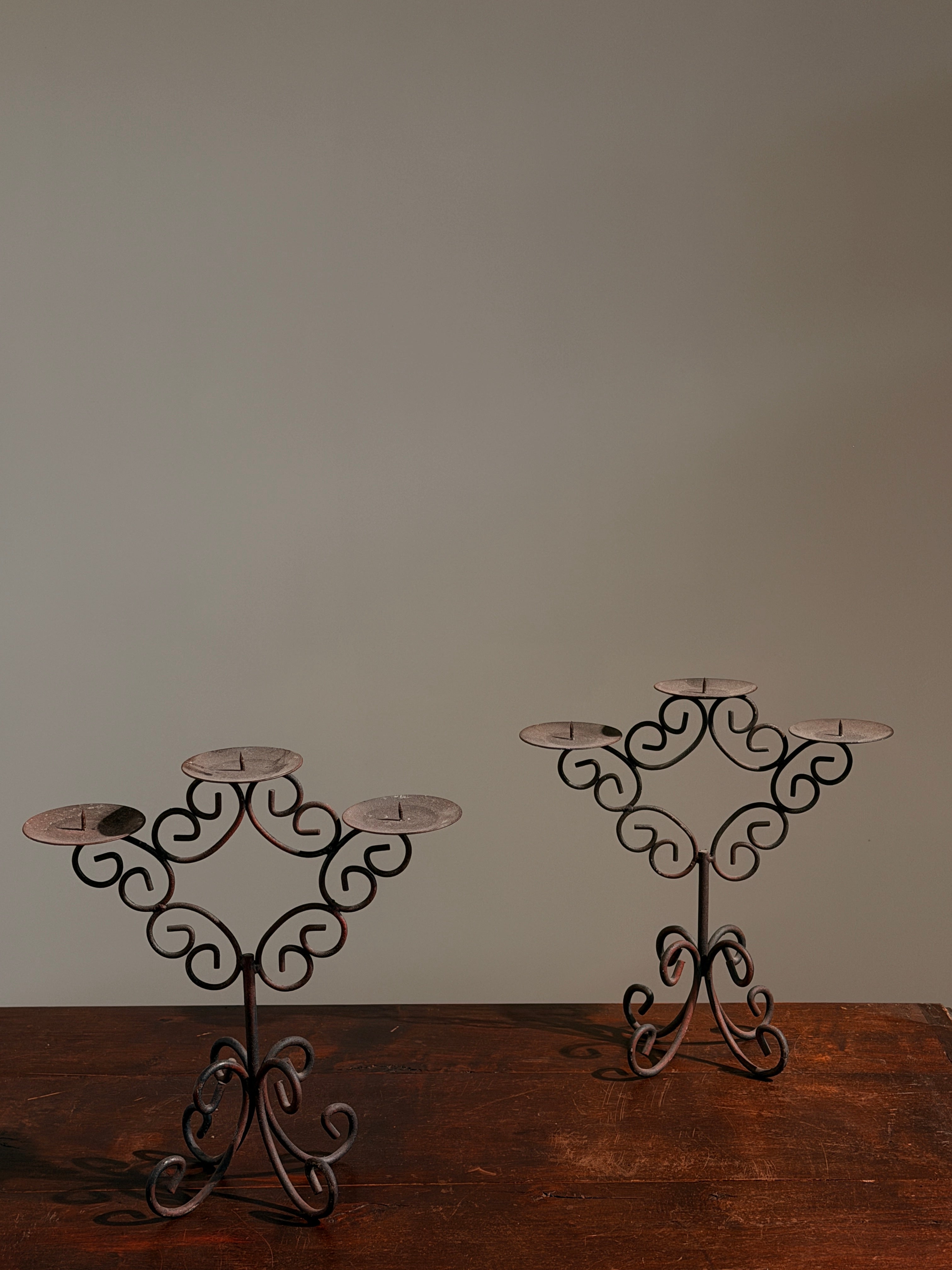 Pair of three-light wrought-iron candleholders, circa 1950 — side angle