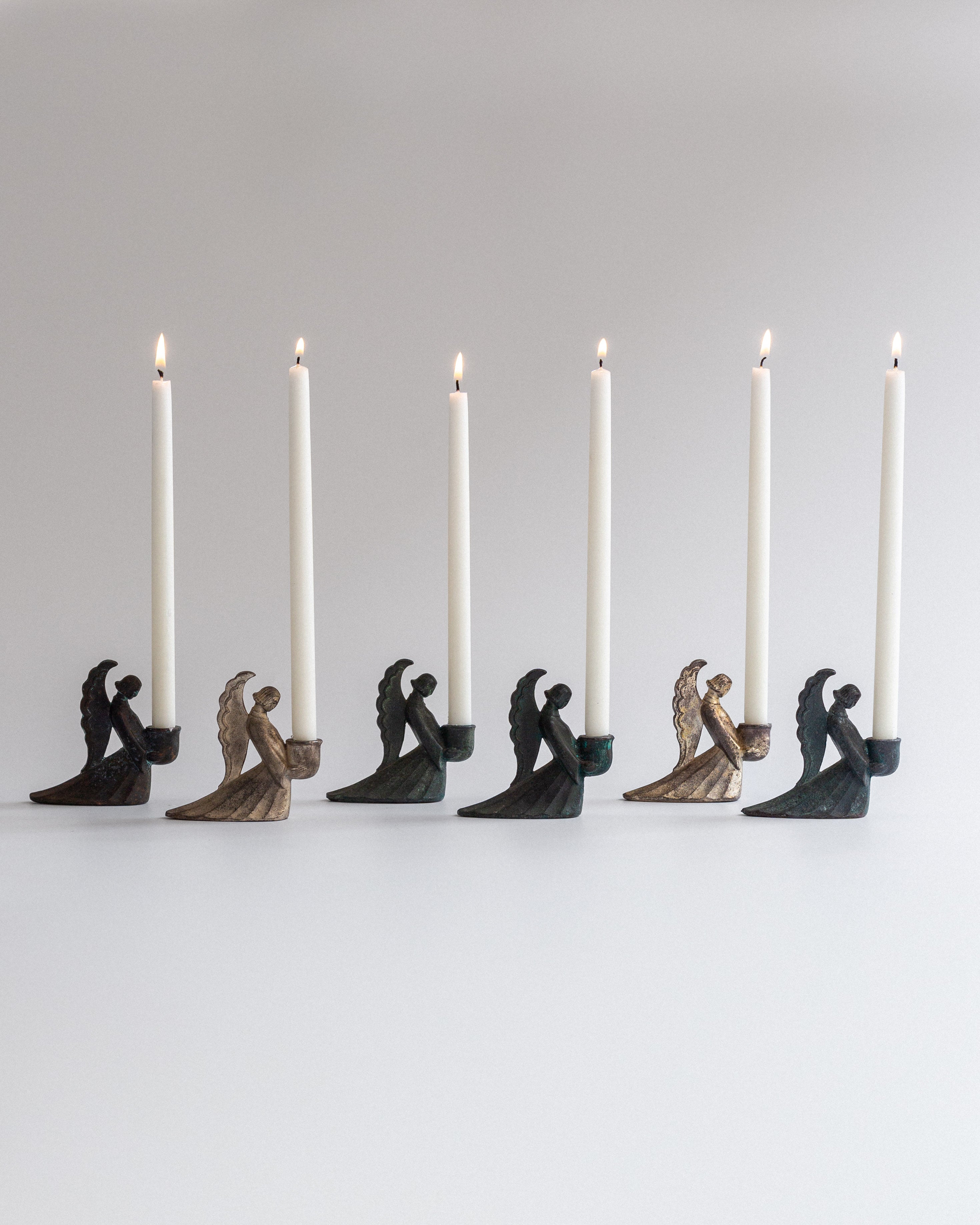 Set of Swedish Art Deco Figural Angel Candlesticks — close-up of candle holders with lit candles