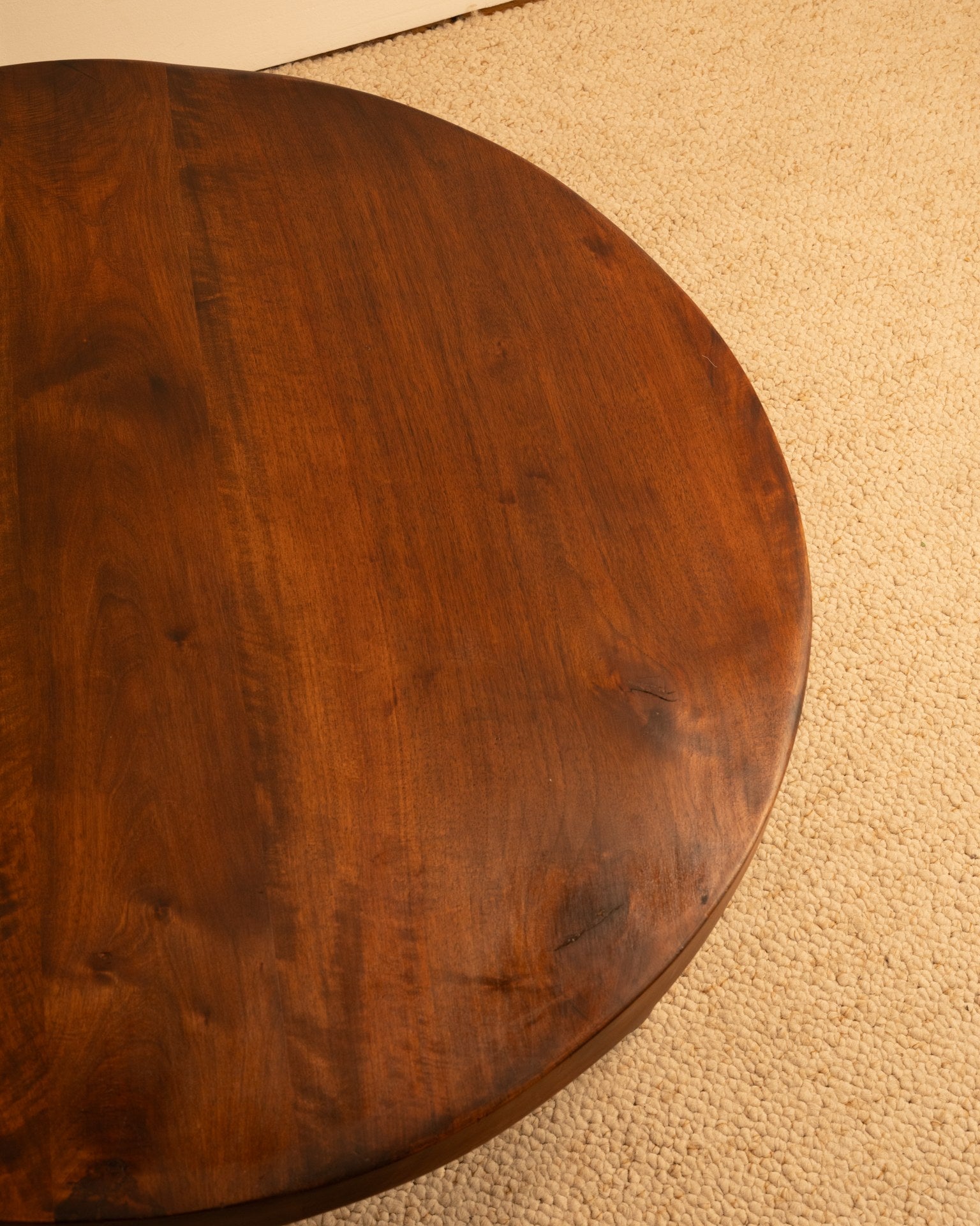 Walnut coffee table top detail showing rich wood grain and curved edge