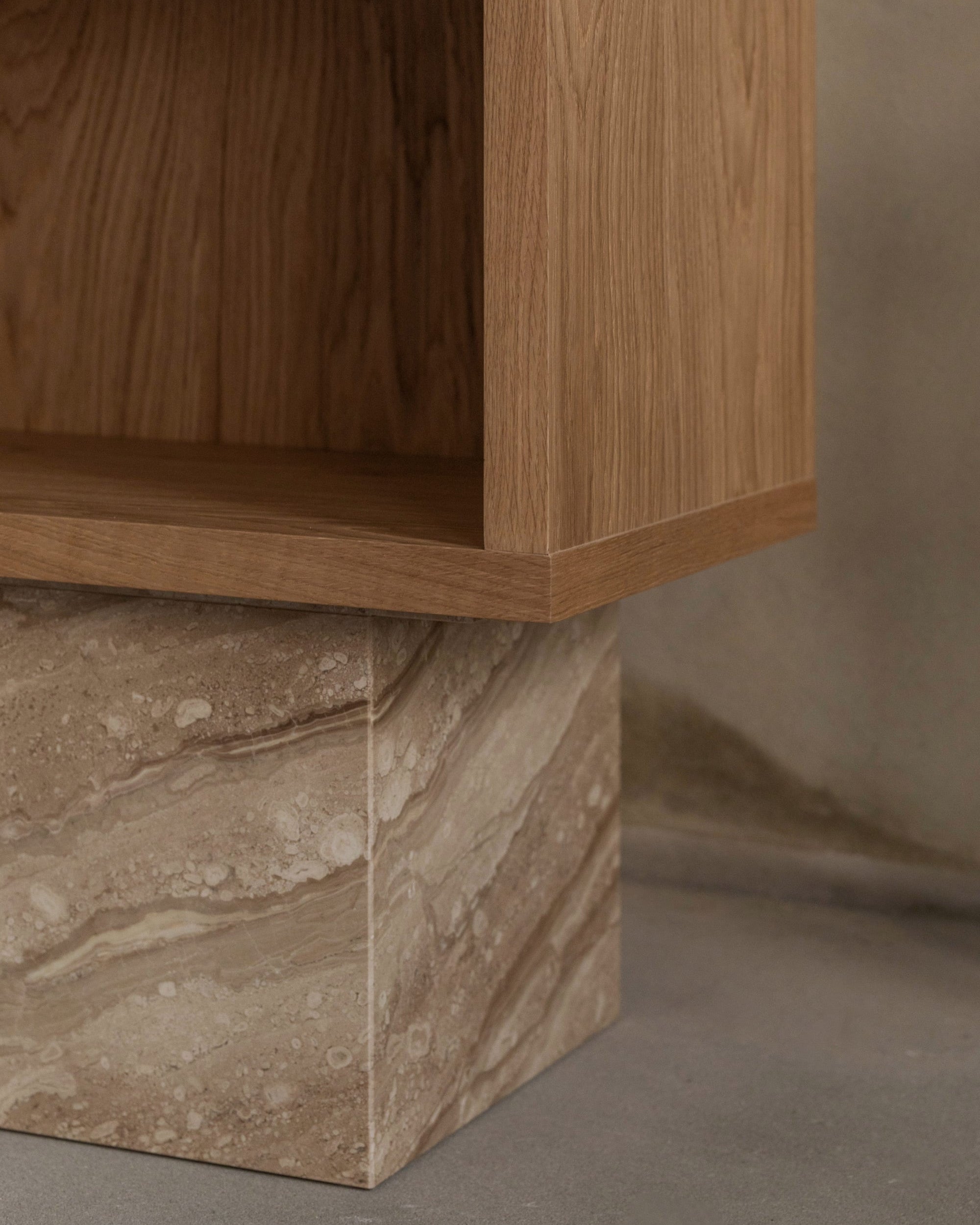 BLOCK cabinet detail showing oak wood grain and marble base junction