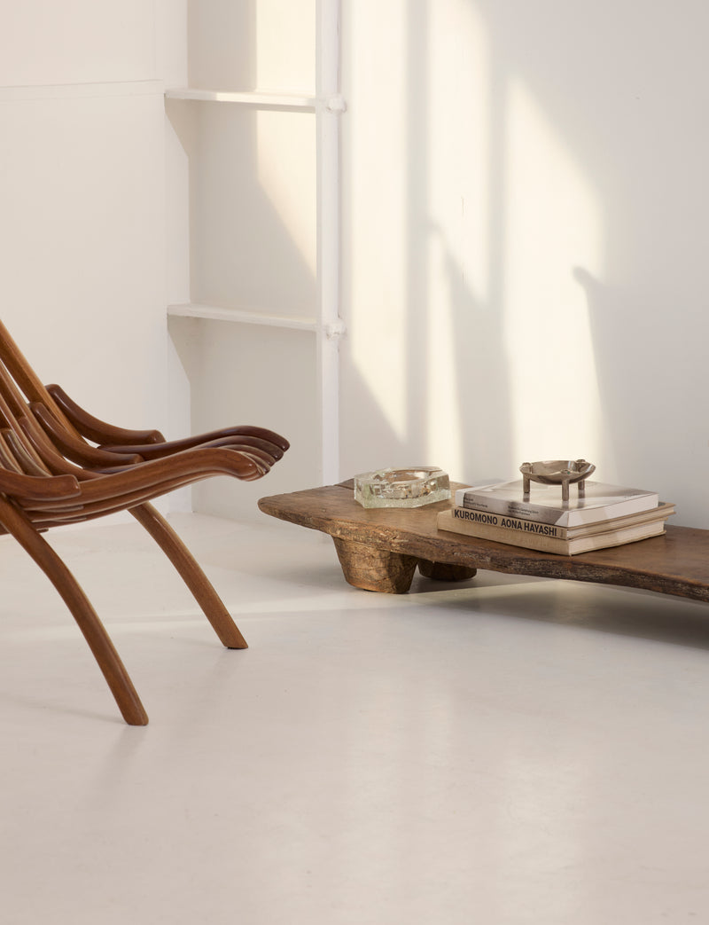 Carved Senufo Bench in Wood — detail of wood grain in bright room