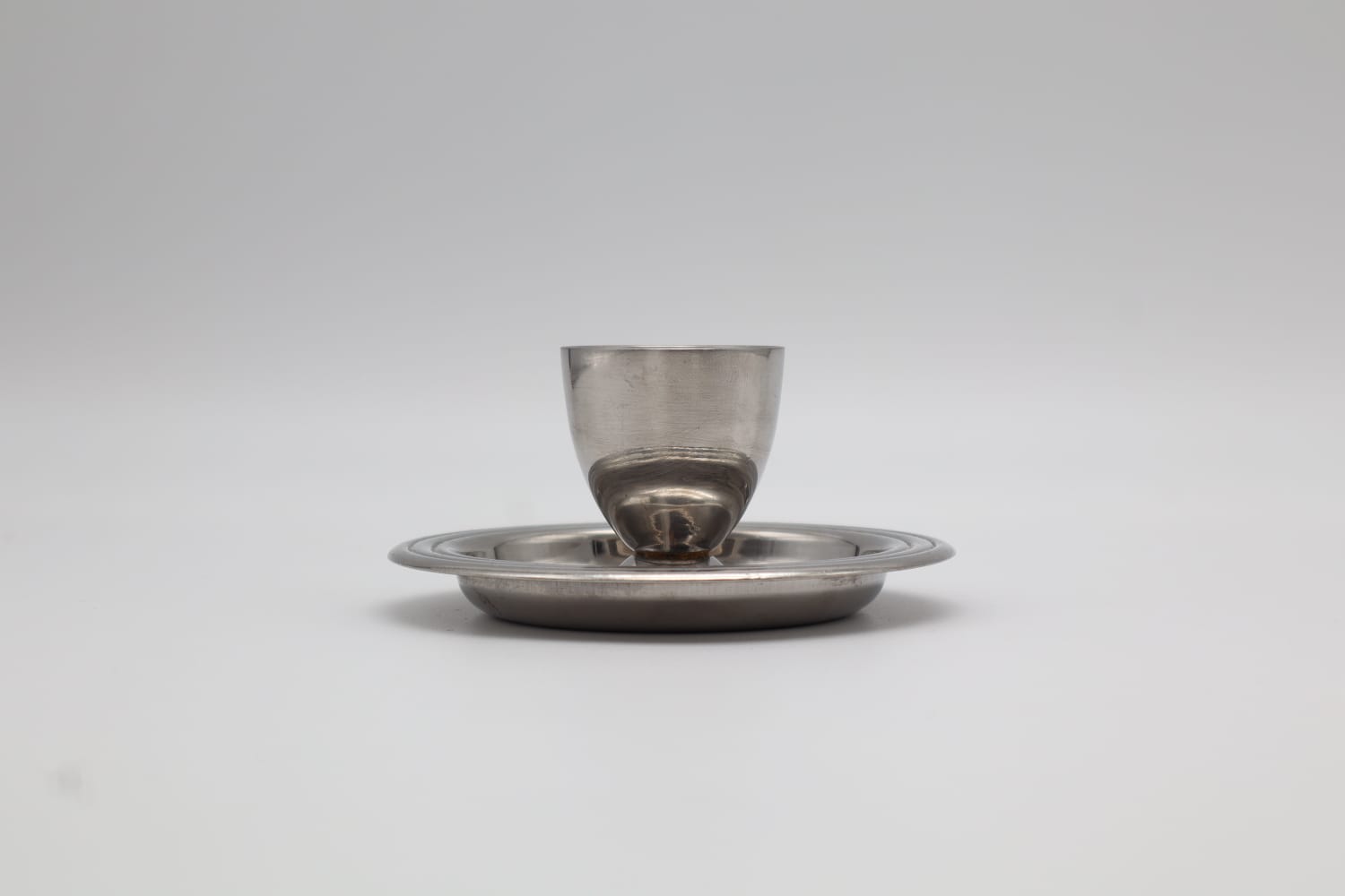 Vintage Stainless Steel Egg Cup – Modernist Saucer Design (c. 1965) — lifestyle setting