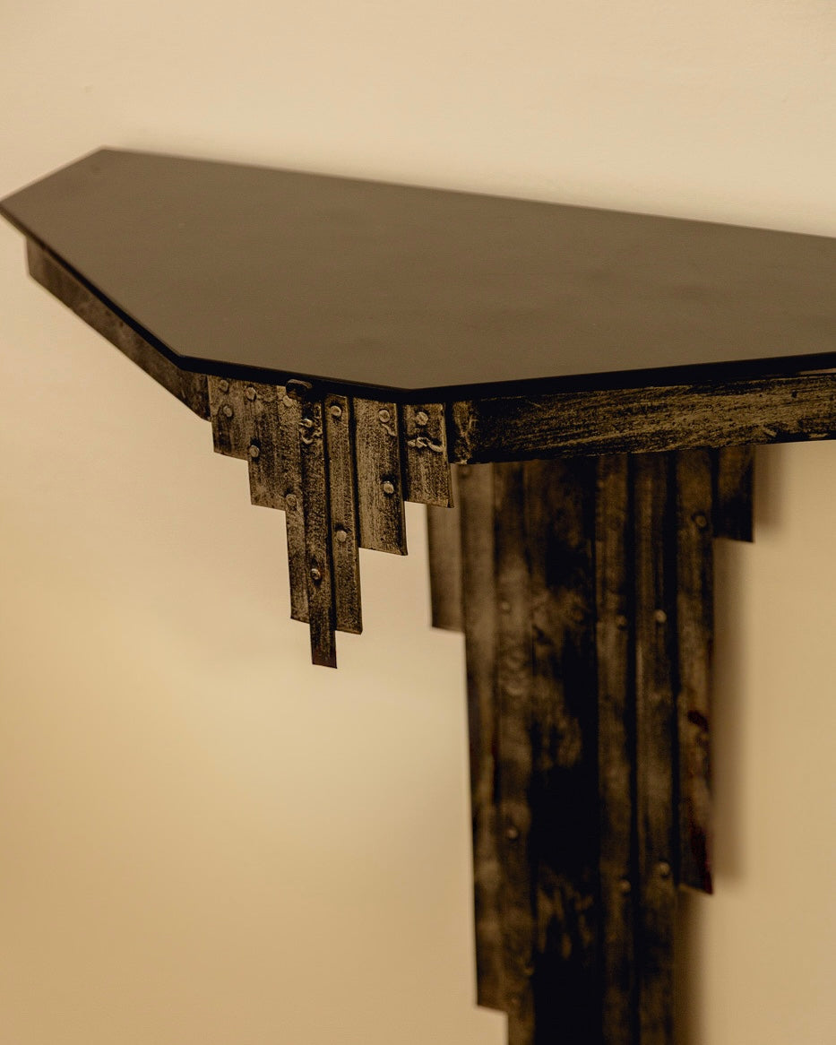 Sculptural Console Table — close-up of black metal edge detail