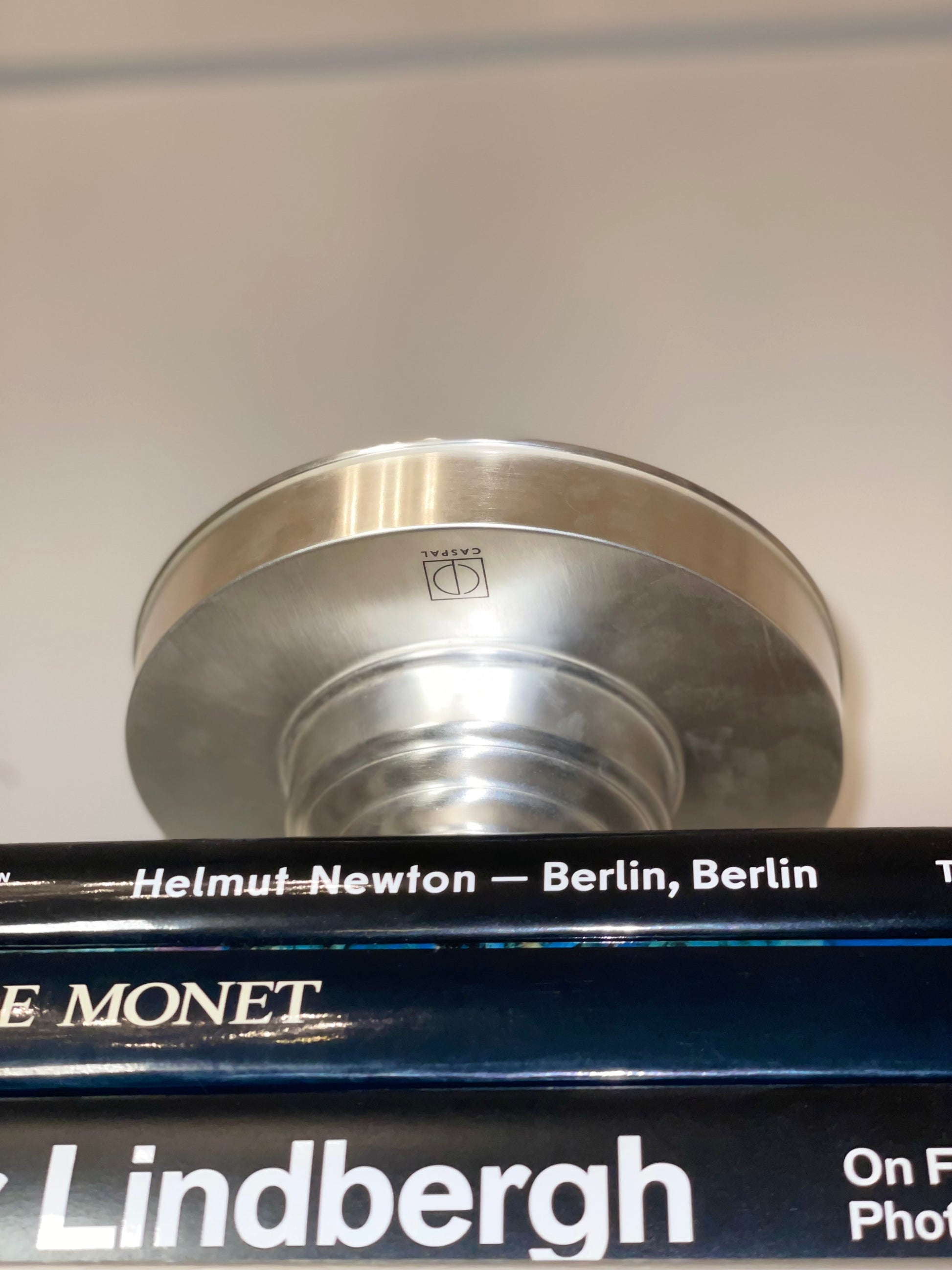 Contemporary Bowl Silver Plated — overhead view on stacked books