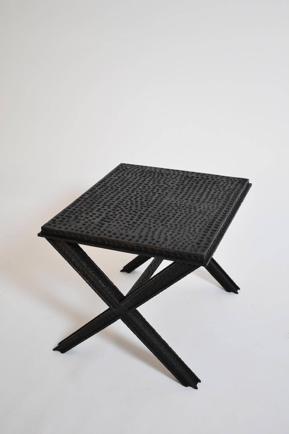 Brutalist Gouged Wood Coffee Table — angled view with textured black surface