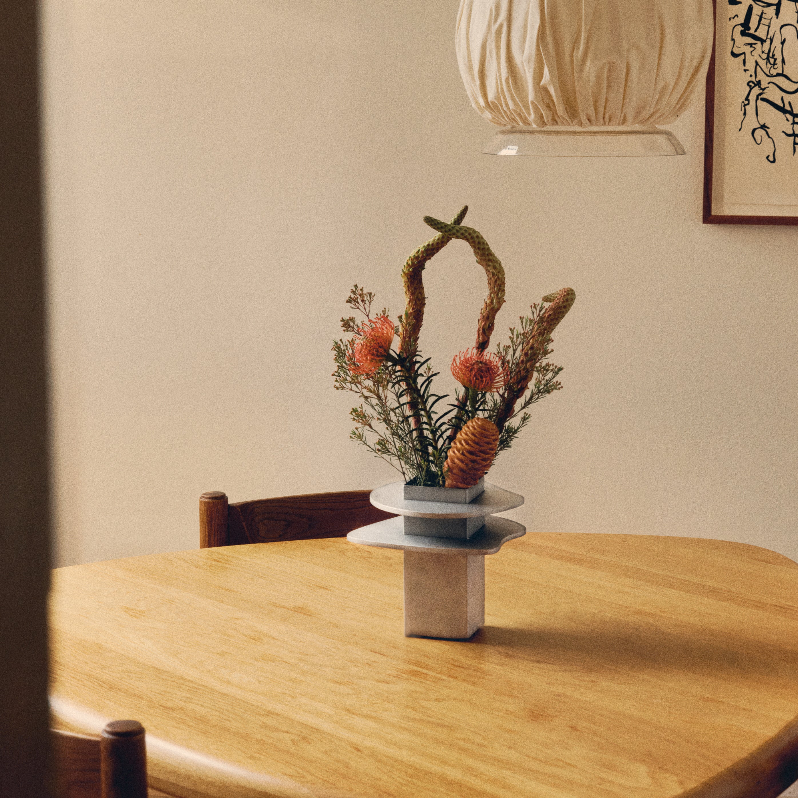 Flange Vase — back view with floral arrangement on wooden table