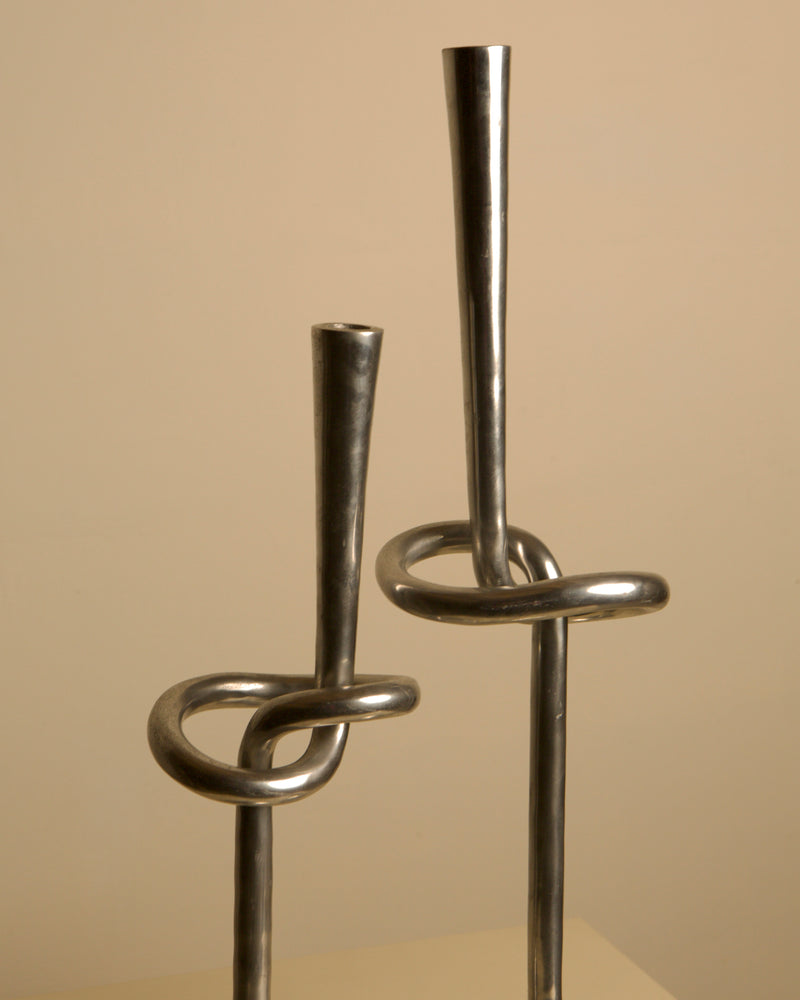 Pair of 80's Aluminum "Knot" Candleholders — close-up of shiny aluminum finish
