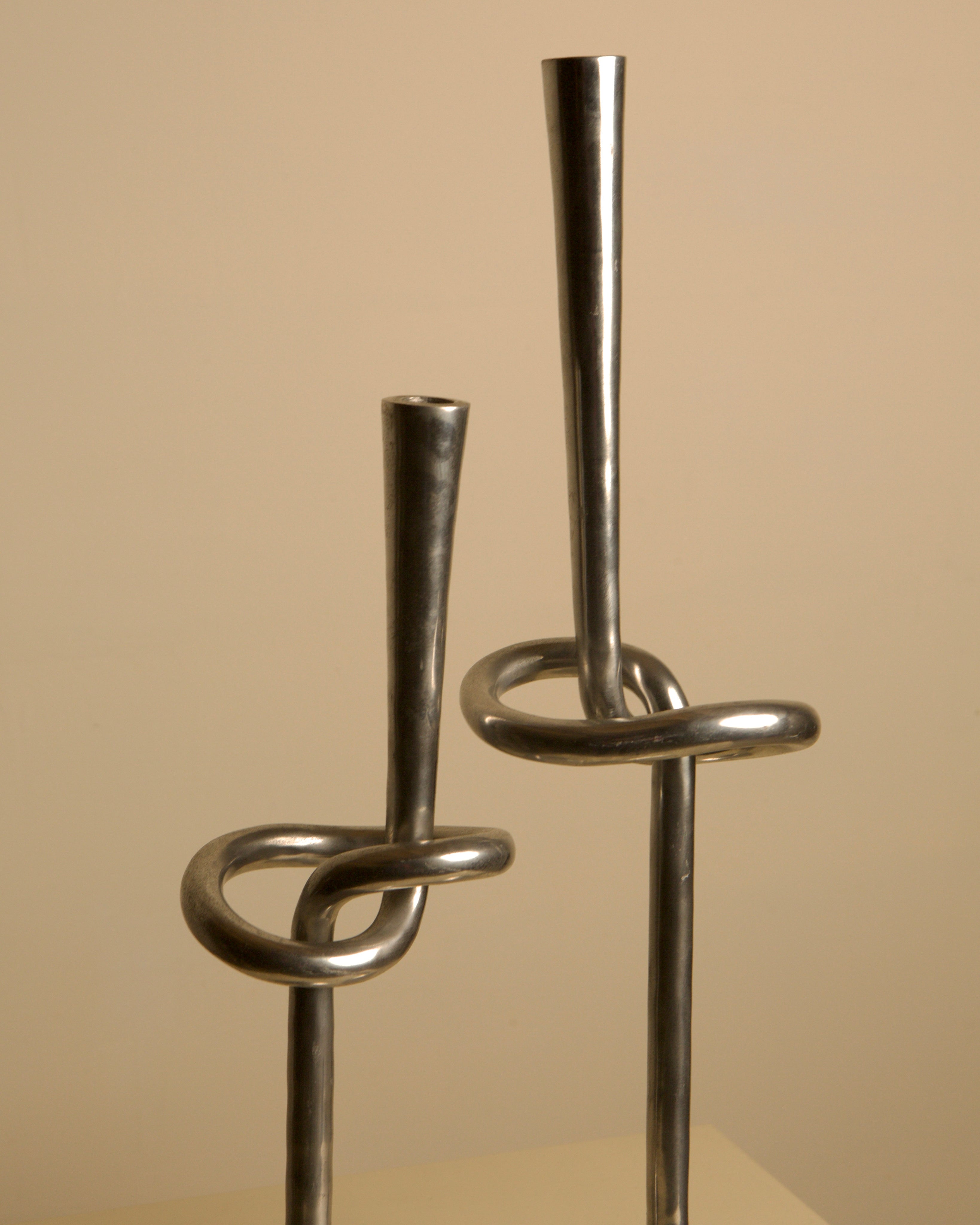 Pair of 80's Aluminum "Knot" Candleholders — close-up of shiny aluminum finish