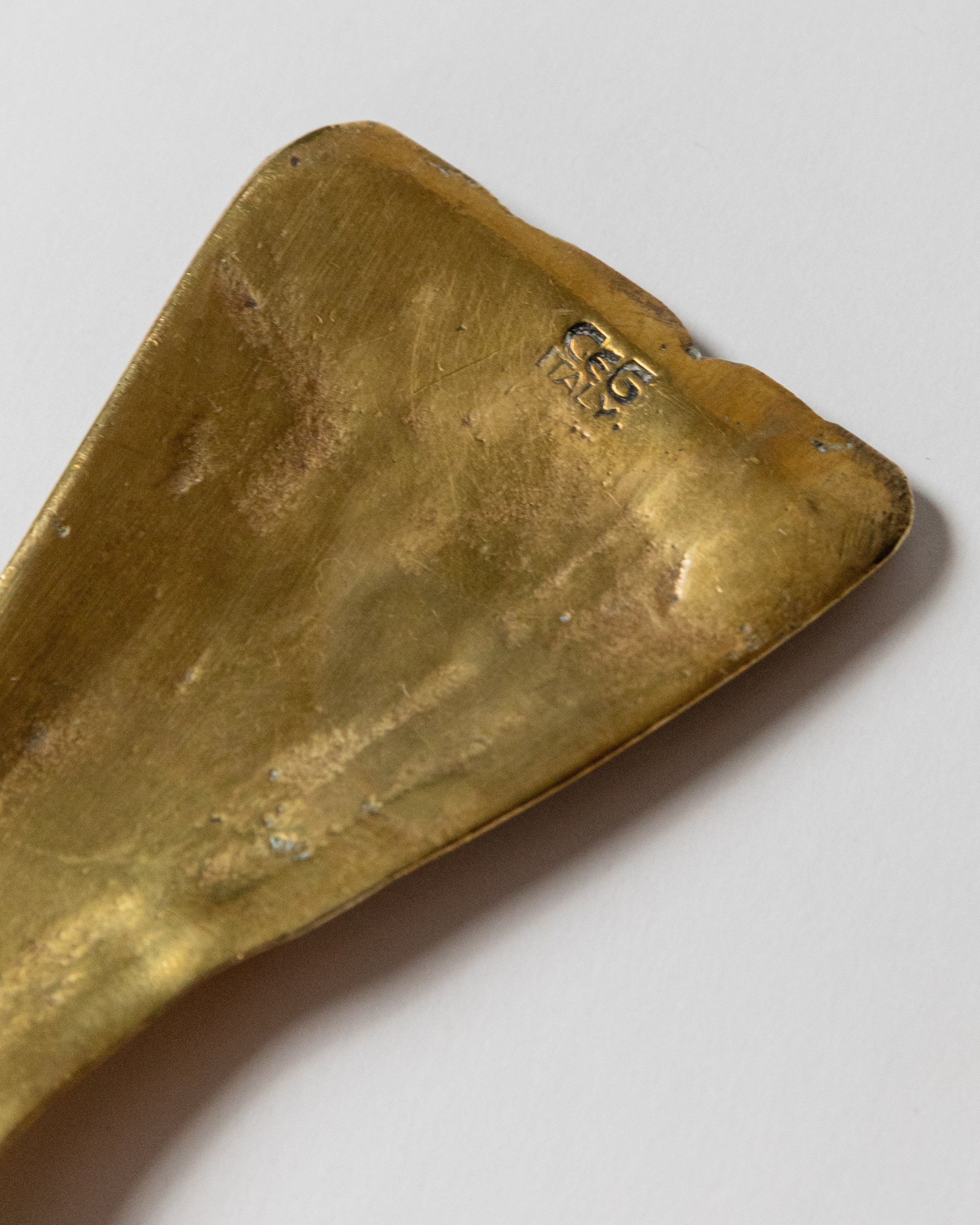 Brass bottle opener CEG Italy marking detail close-up view