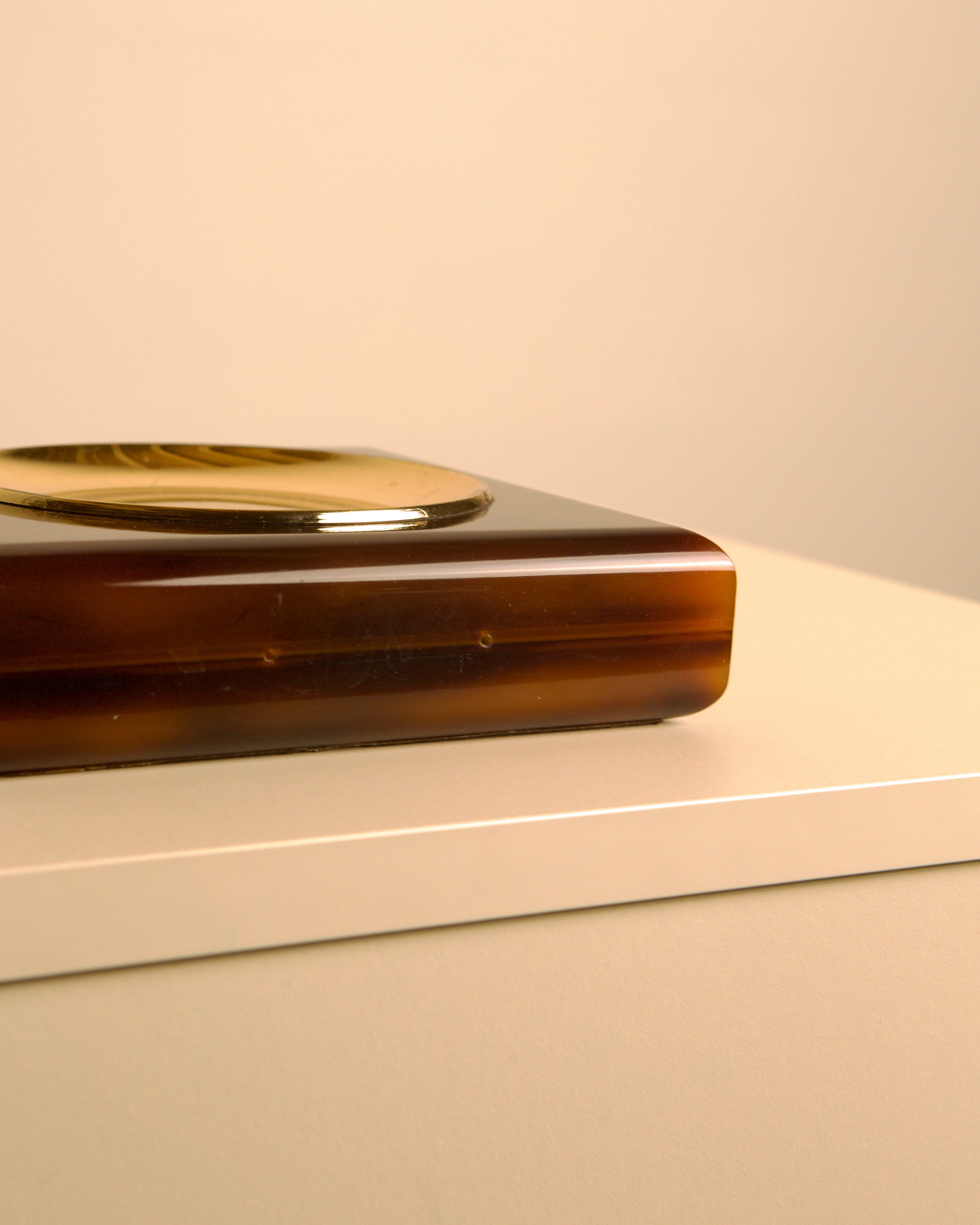70's Italian Resin Tortoise Shell Effect Valet Tray — side angle on light surface