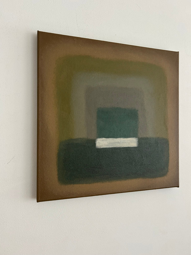 The Forrest Walk Painting by Iris Bavelaar features layered, blurred rectangles in brown, green, and gray on a light wall, with a horizontal white bar near the base of the dark central shape.