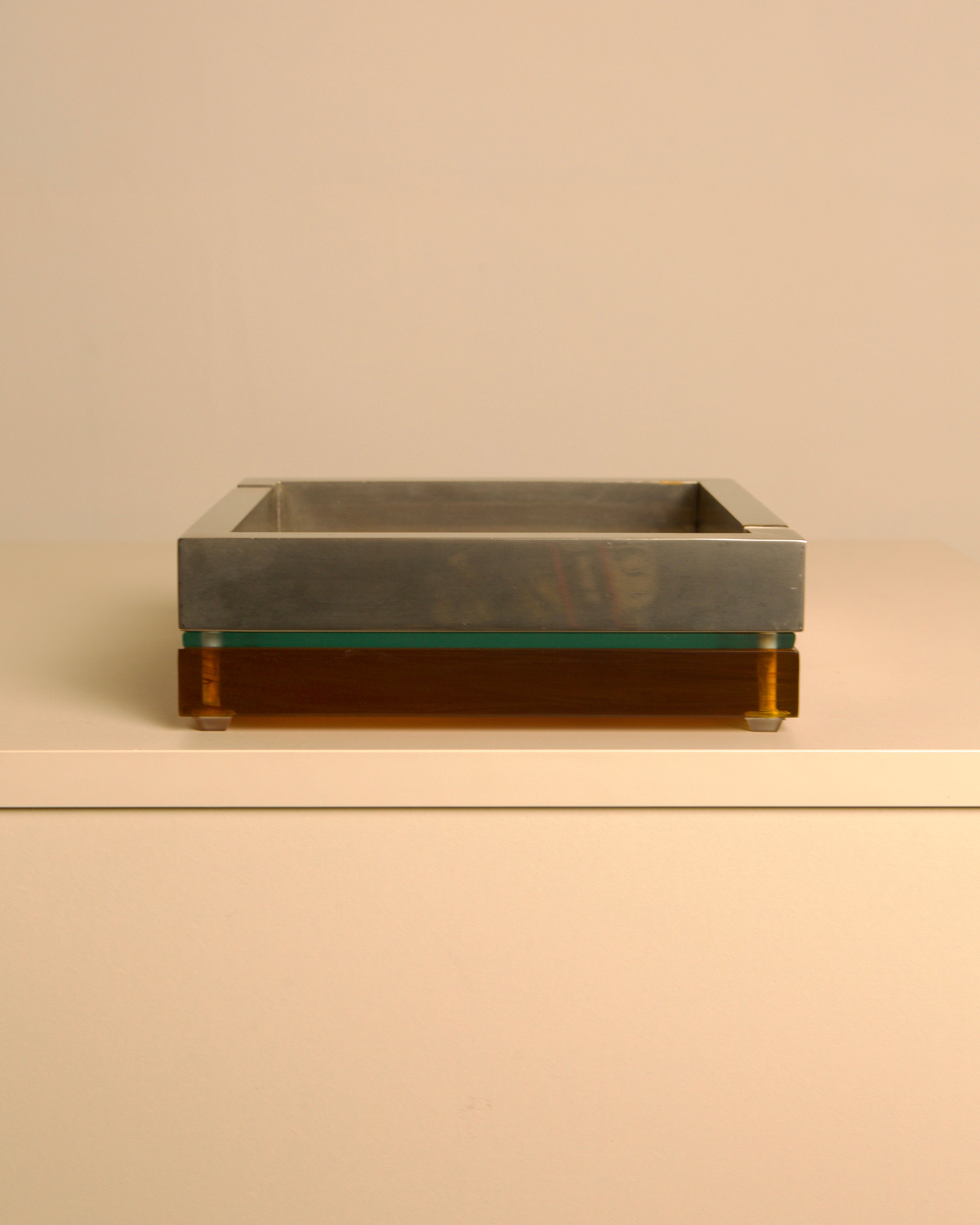 Large 70s Italian square ashtray in metal, glass and light smoked Plexiglas — side angle
