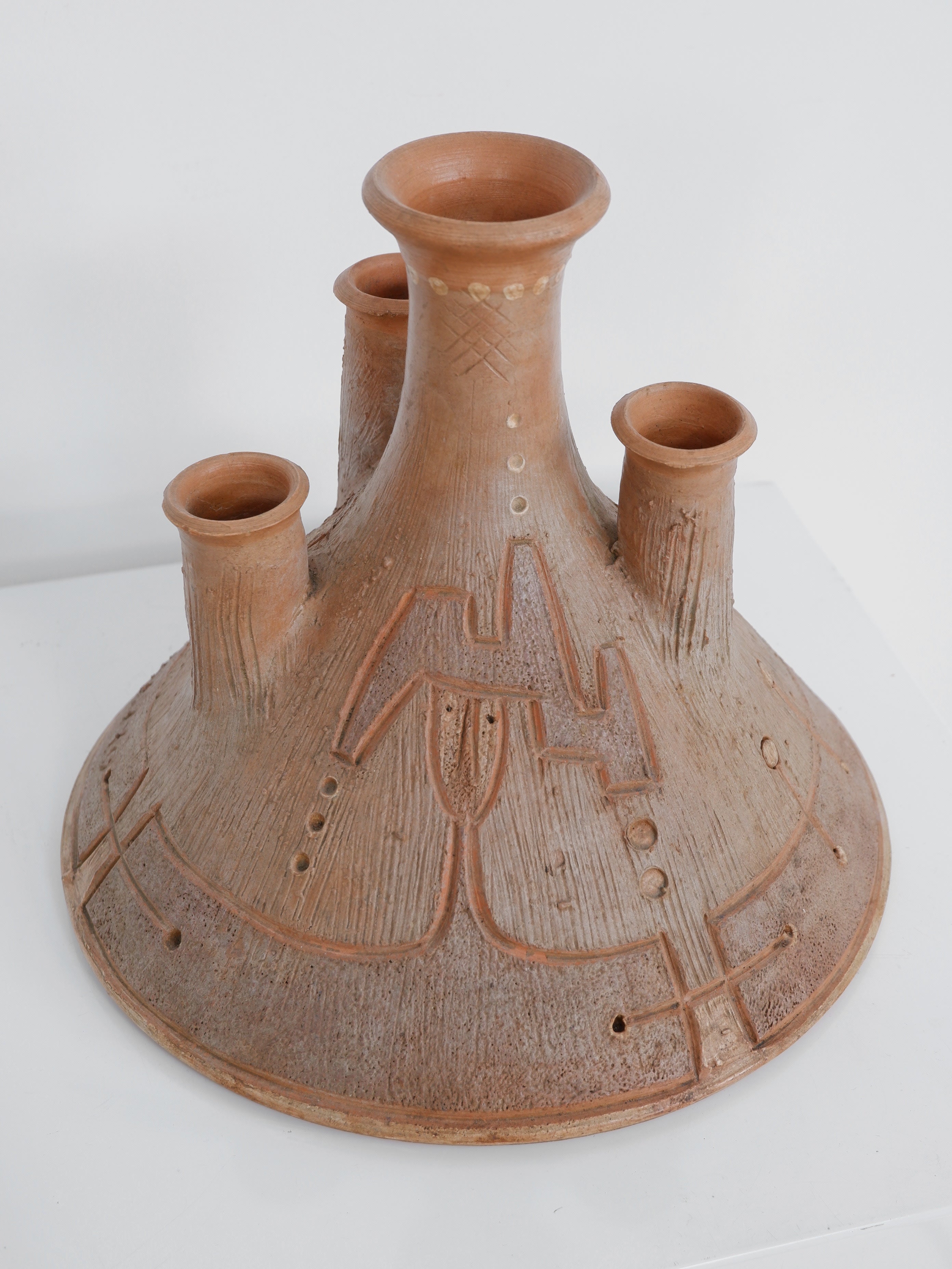 Vintage terracotta ceramic candelabra with geometric pattern detail