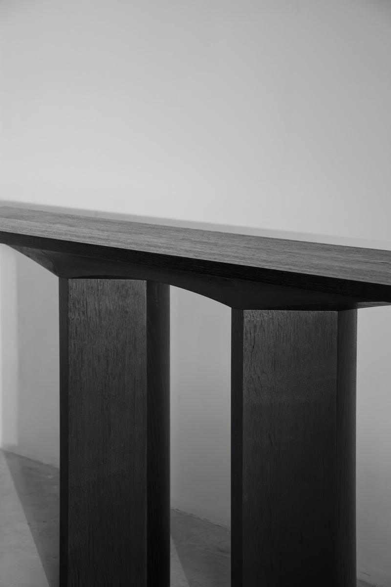 Corps - Console — close-up of dark wooden tabletop and legs