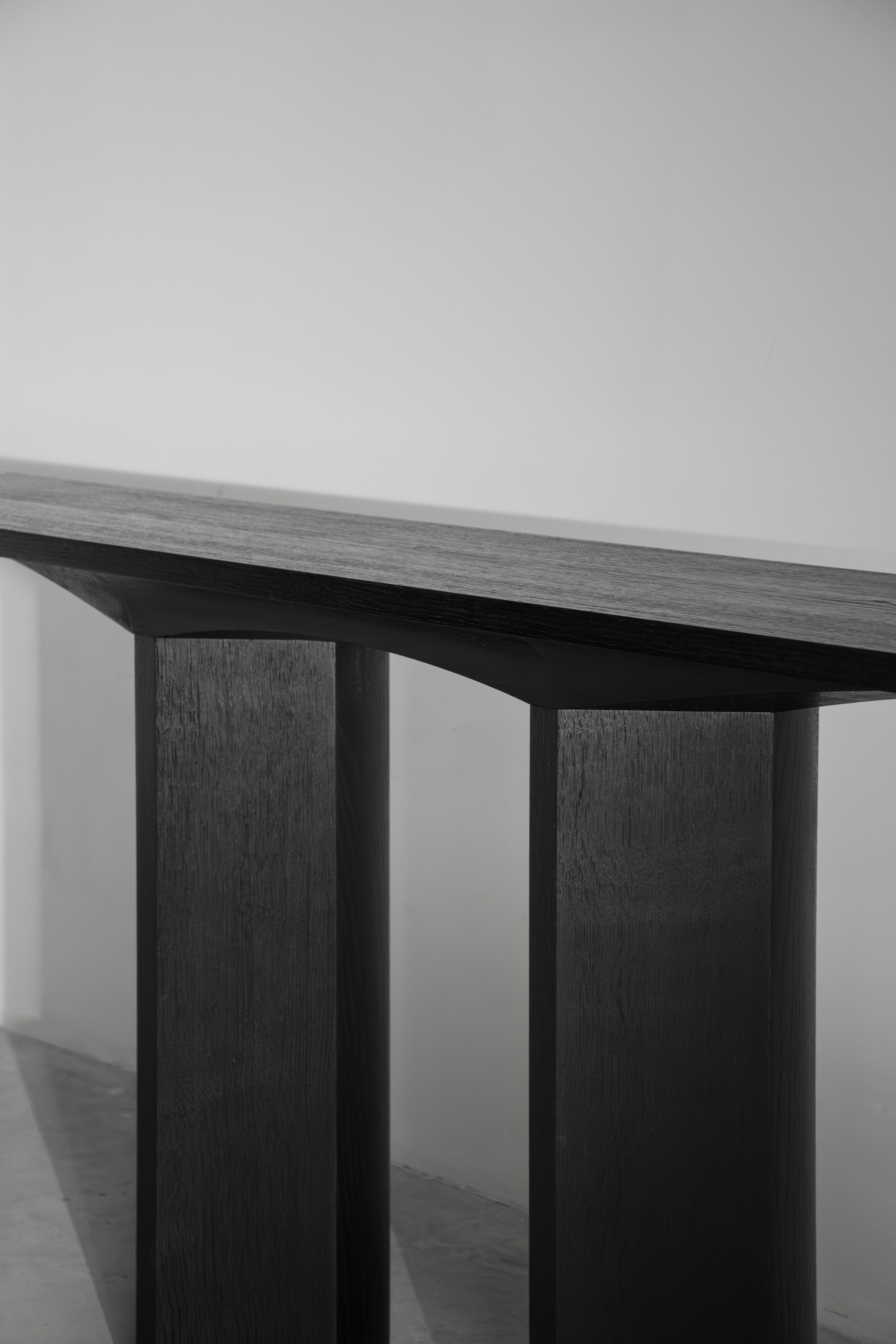 Corps - Console — close-up of dark wooden tabletop and legs
