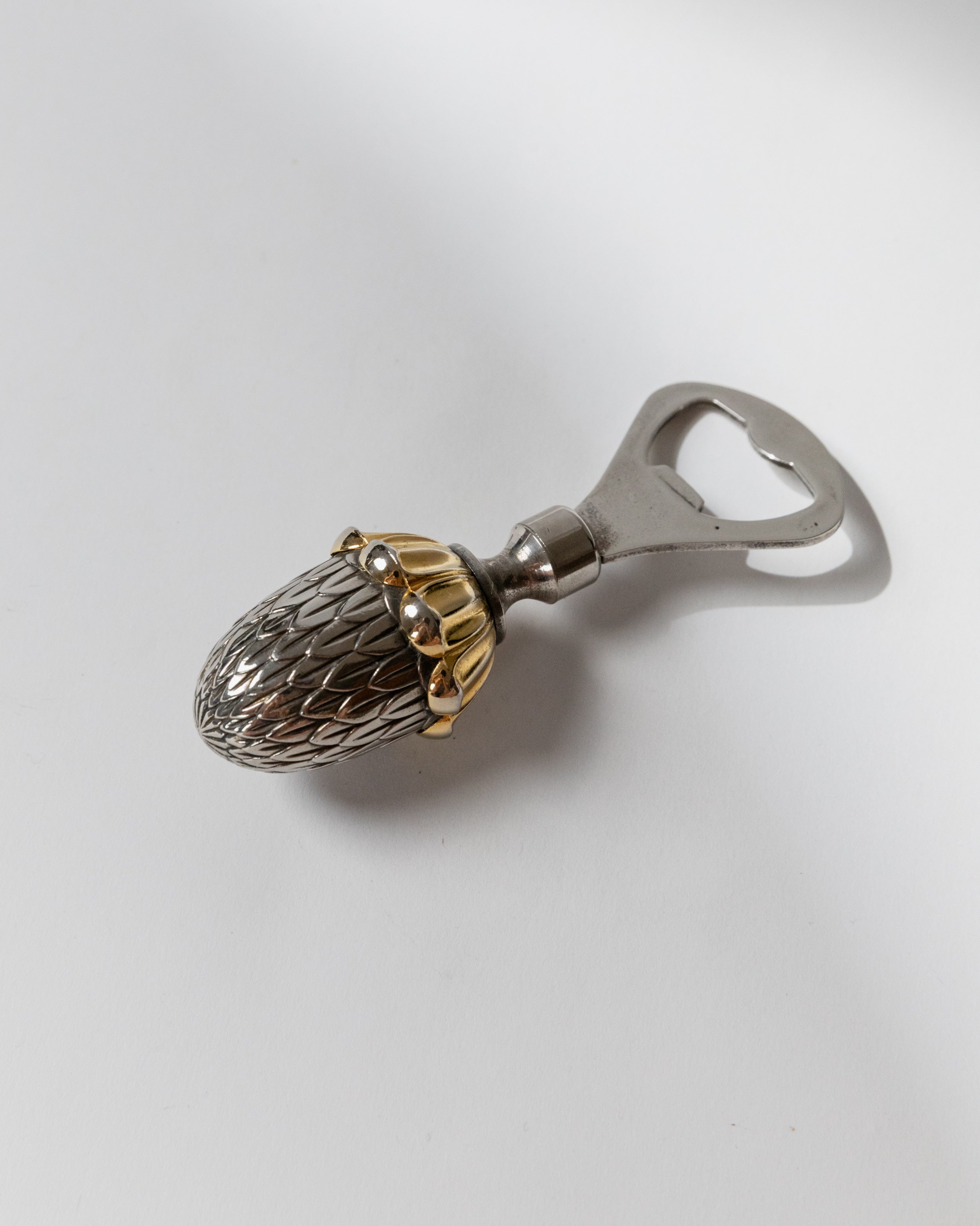 Acorn-shaped silver plated bottle opener with textured surface detail