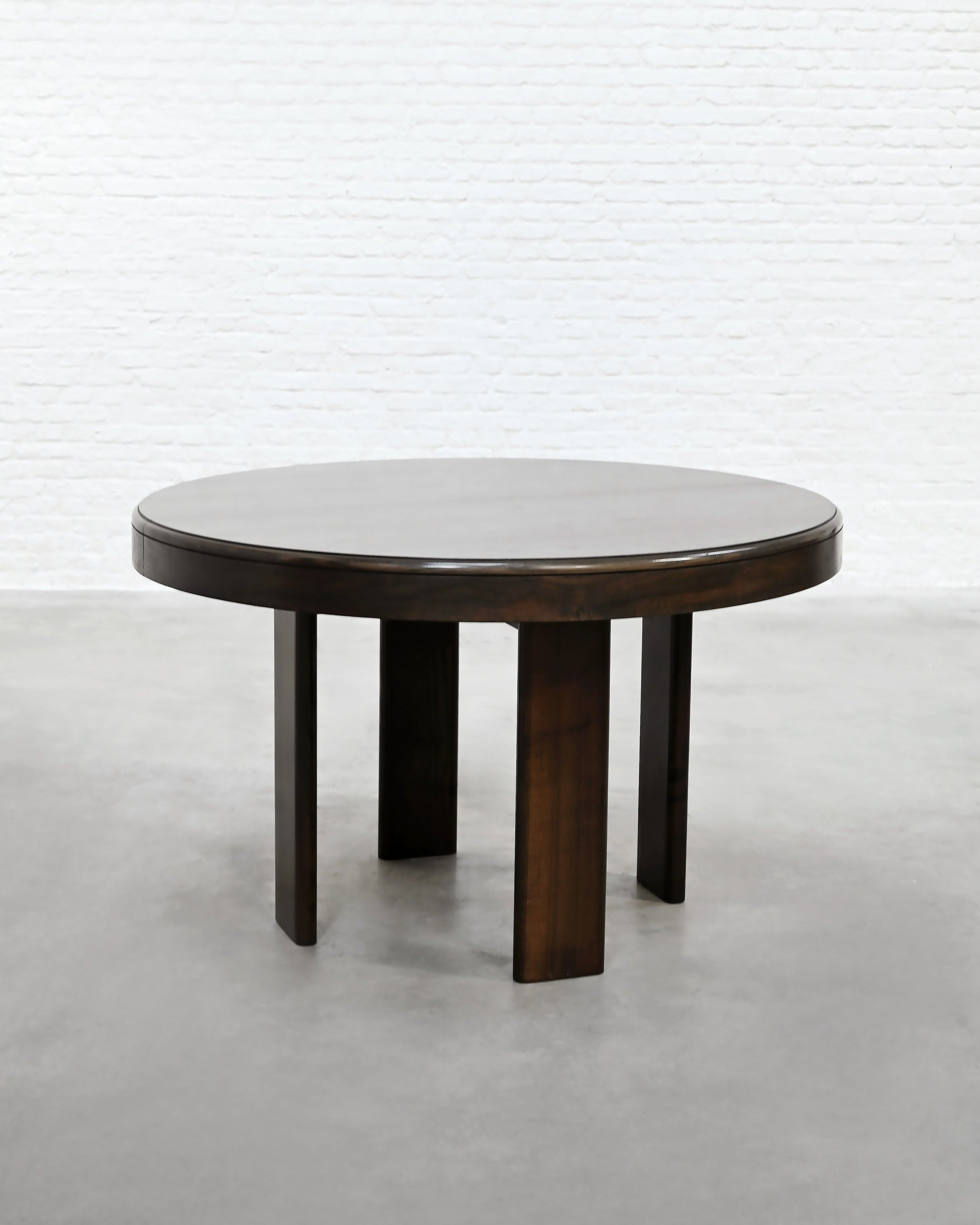 Round dark wood dining table with four cylindrical legs, Italian 1960s design