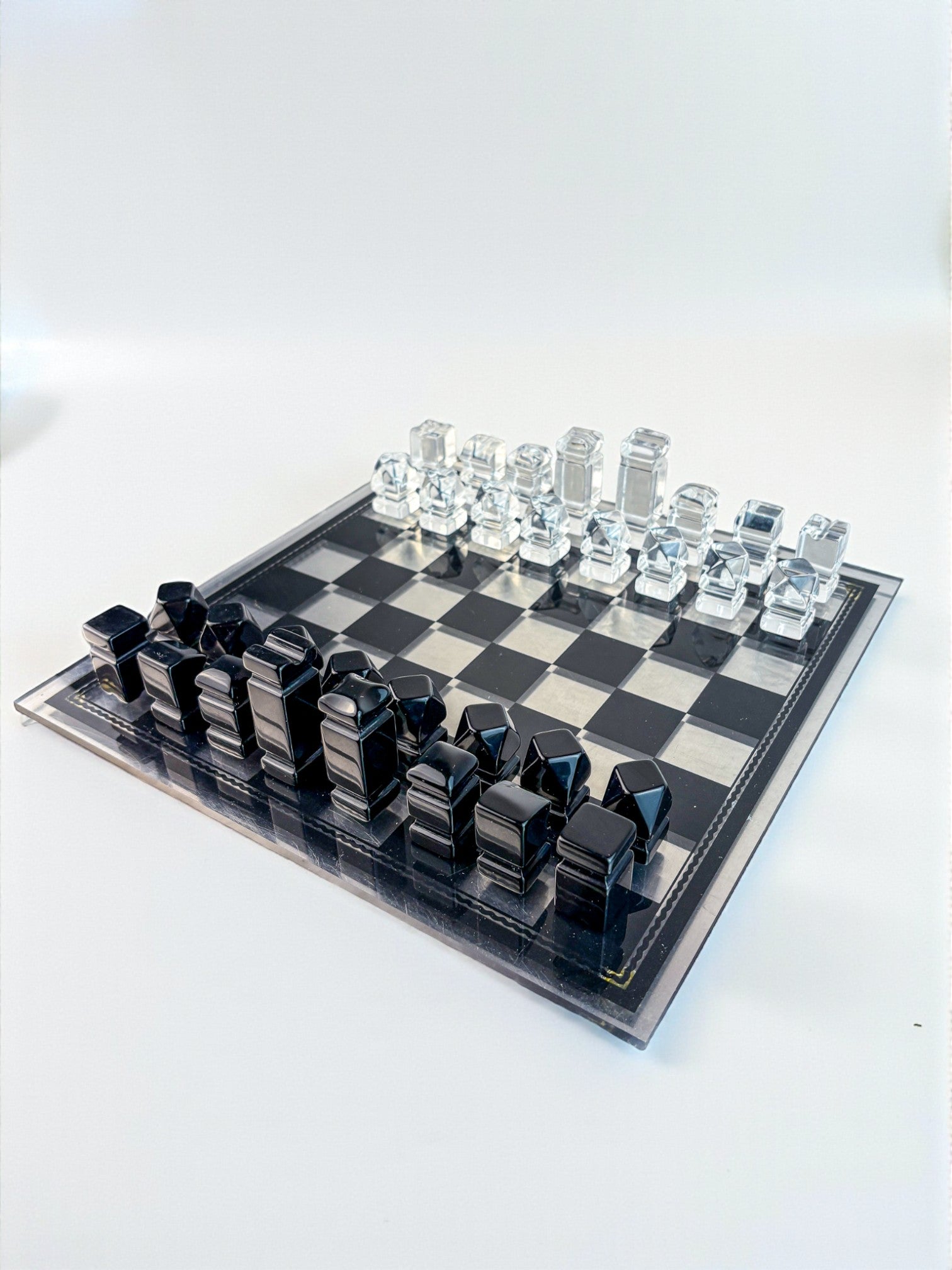 Felice Antonio Botta Acrylic Chessboard, Italy, 70s — angled view of black and clear acrylic pieces