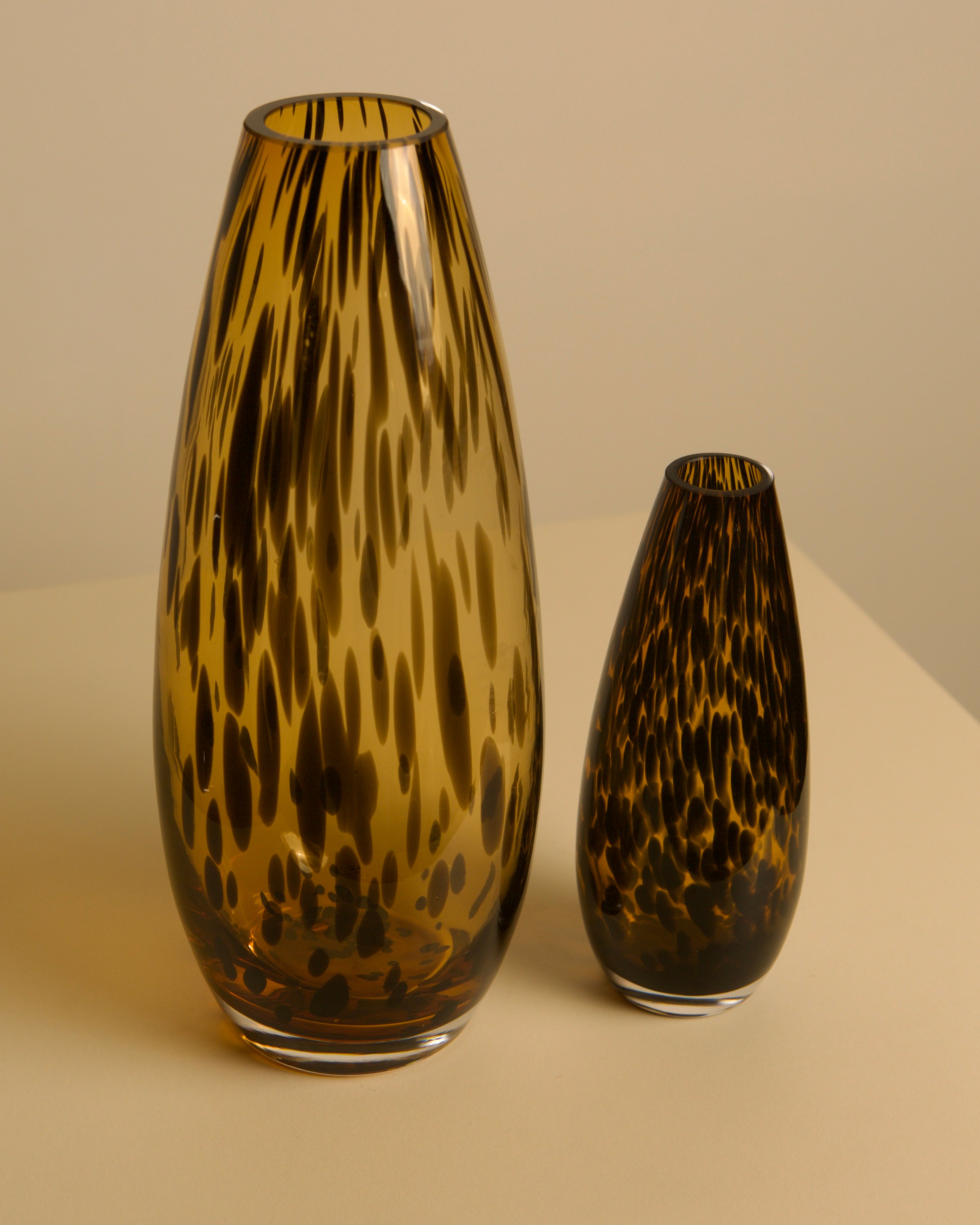 Pair of "Leopard" Murano Glass Vases from the 1980s — angled view on neutral surface