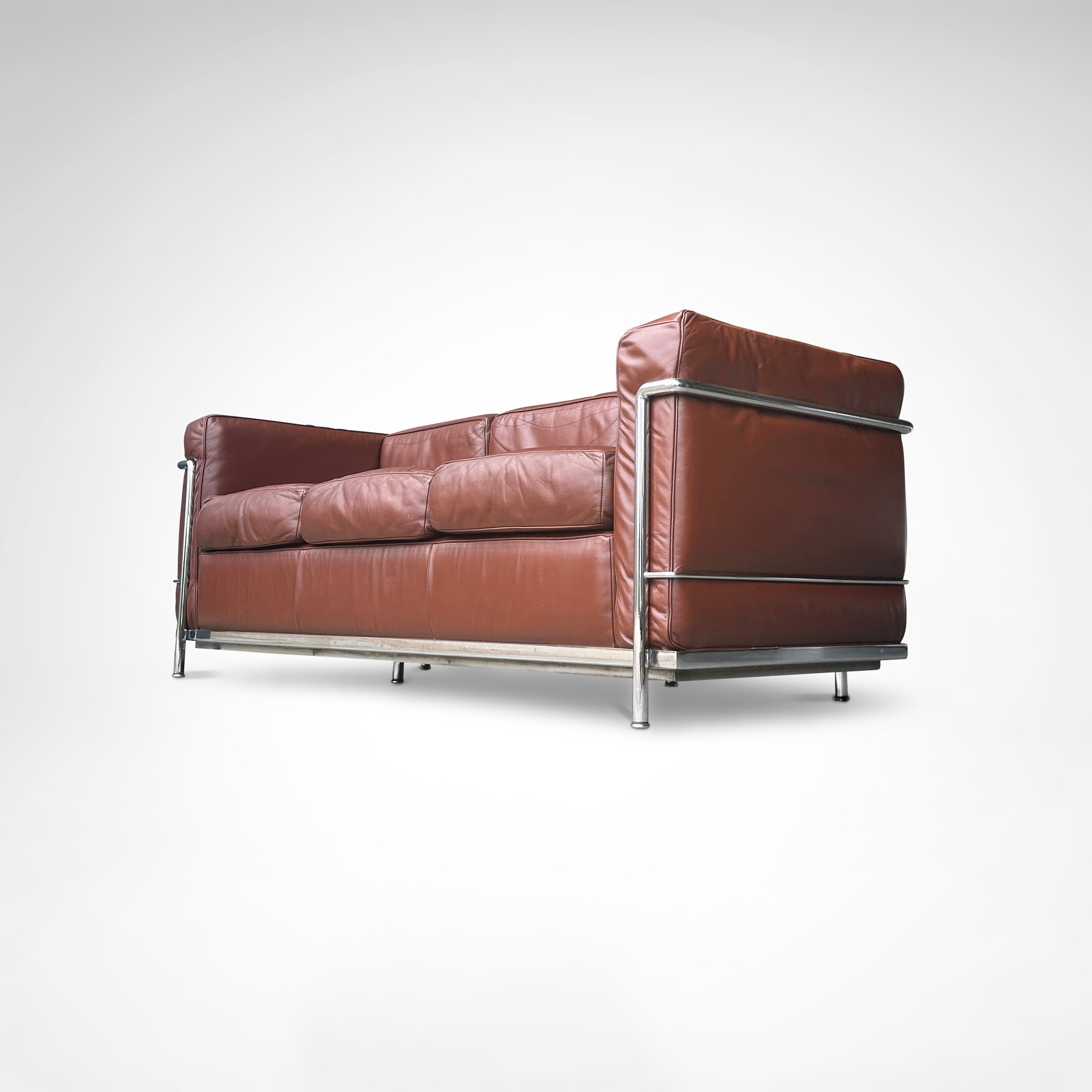 Early production LC2 leather 3-seater sofa by Le Corbusier et al Cassina 1970s — low angle view highlighting rich brown leath