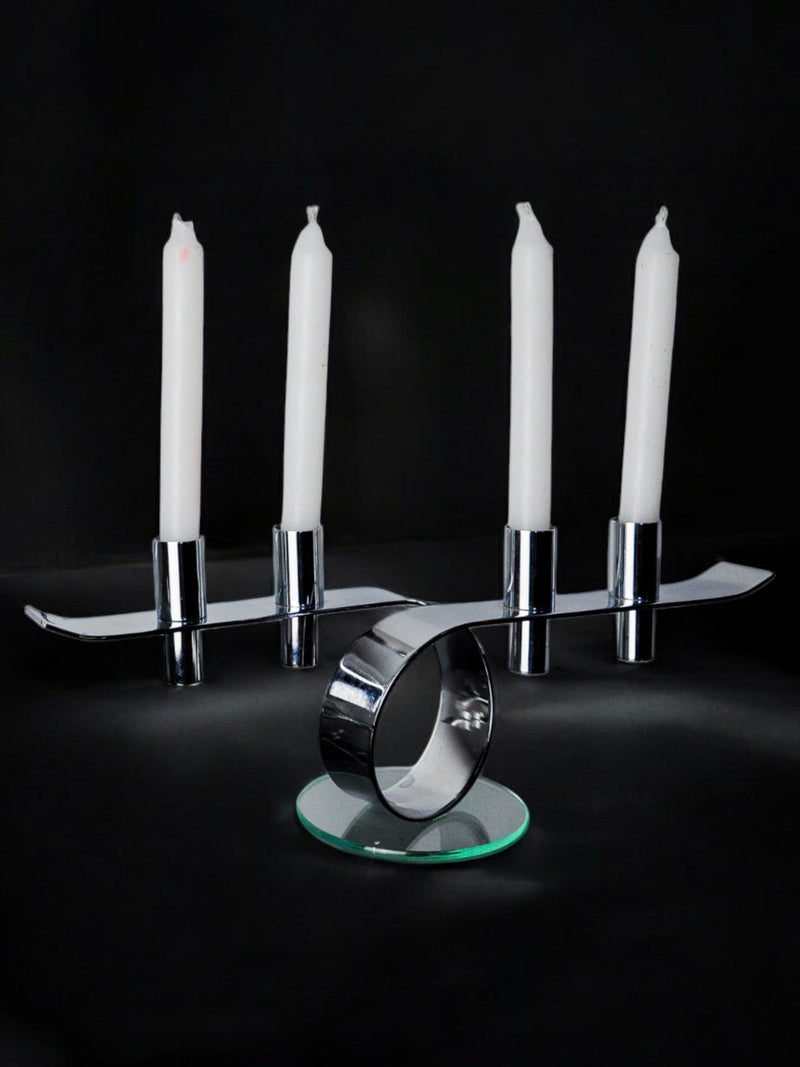 Space-age 4-flame candlestick, glass and metal, Germany, 1980 — close-up of chrome base with white candles