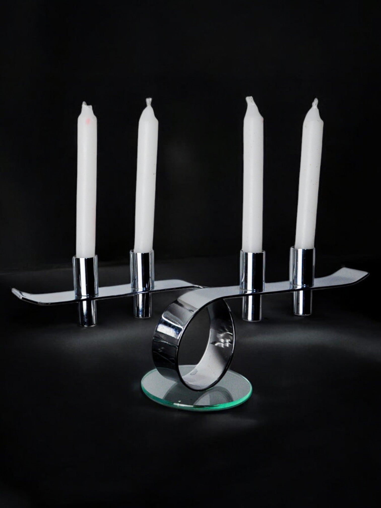 Space-age 4-flame candlestick, glass and metal, Germany, 1980 — close-up of chrome base with white candles