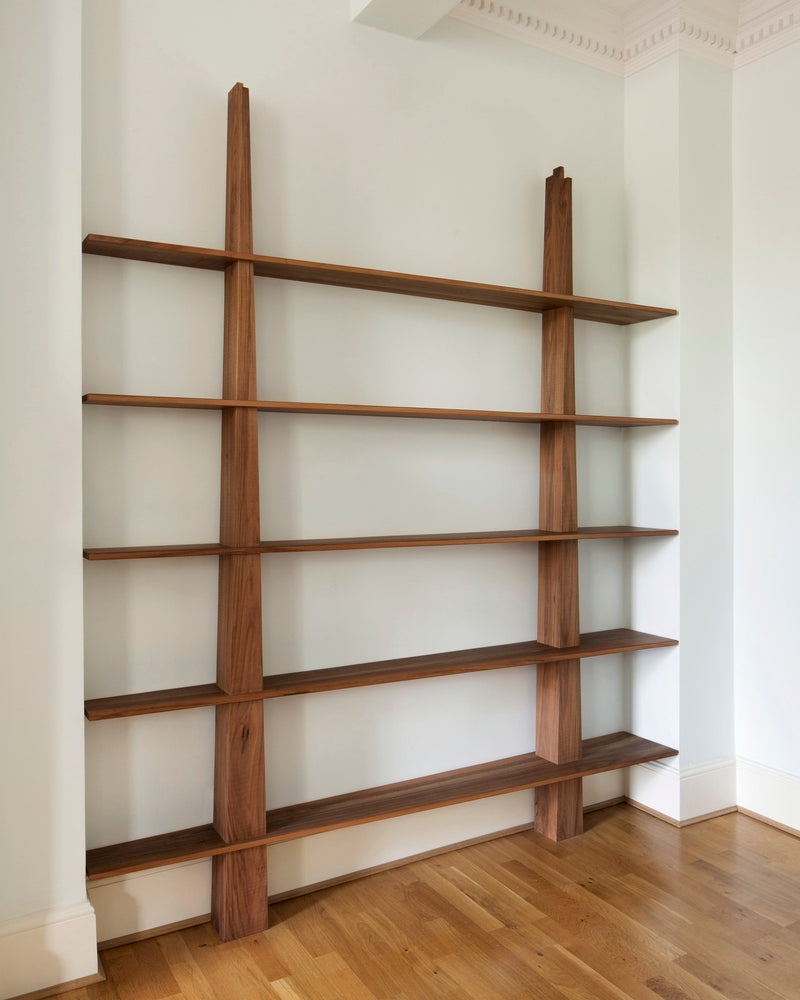 Greg Bookcase — close-up of walnut shelves against white wall