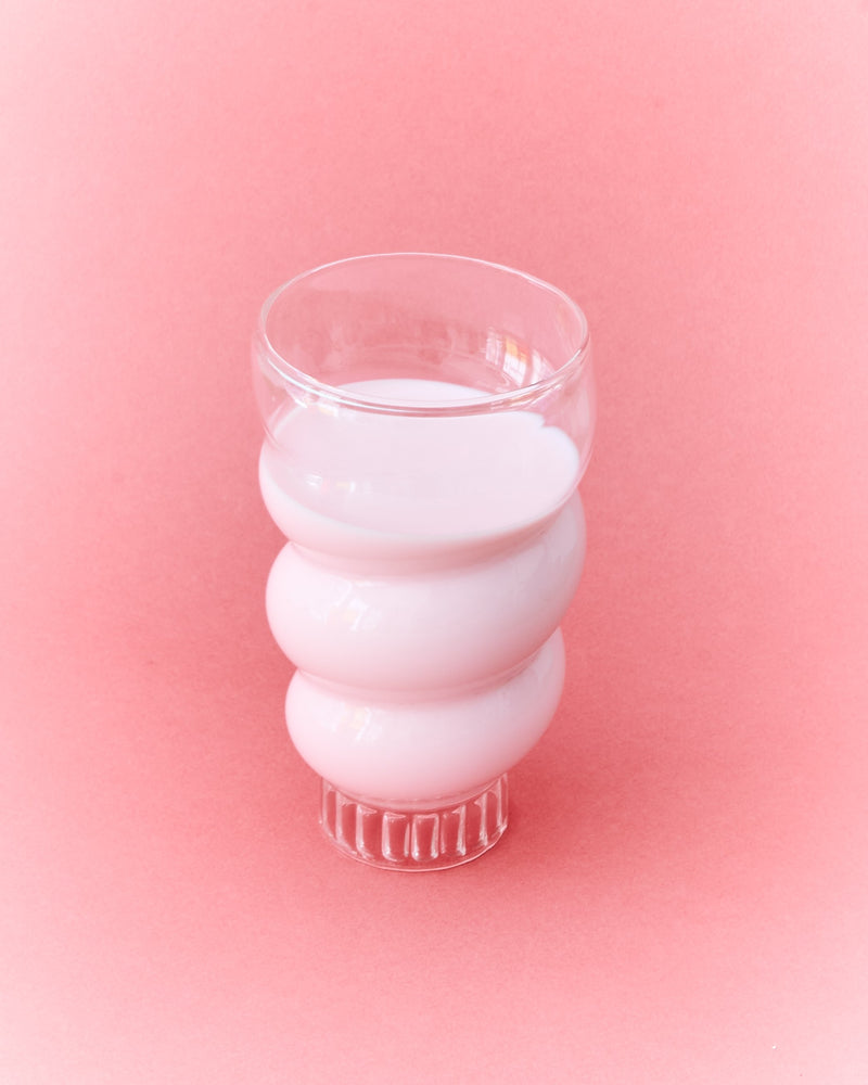 Stacked Paguro ribbed glasses in translucent white glass detail