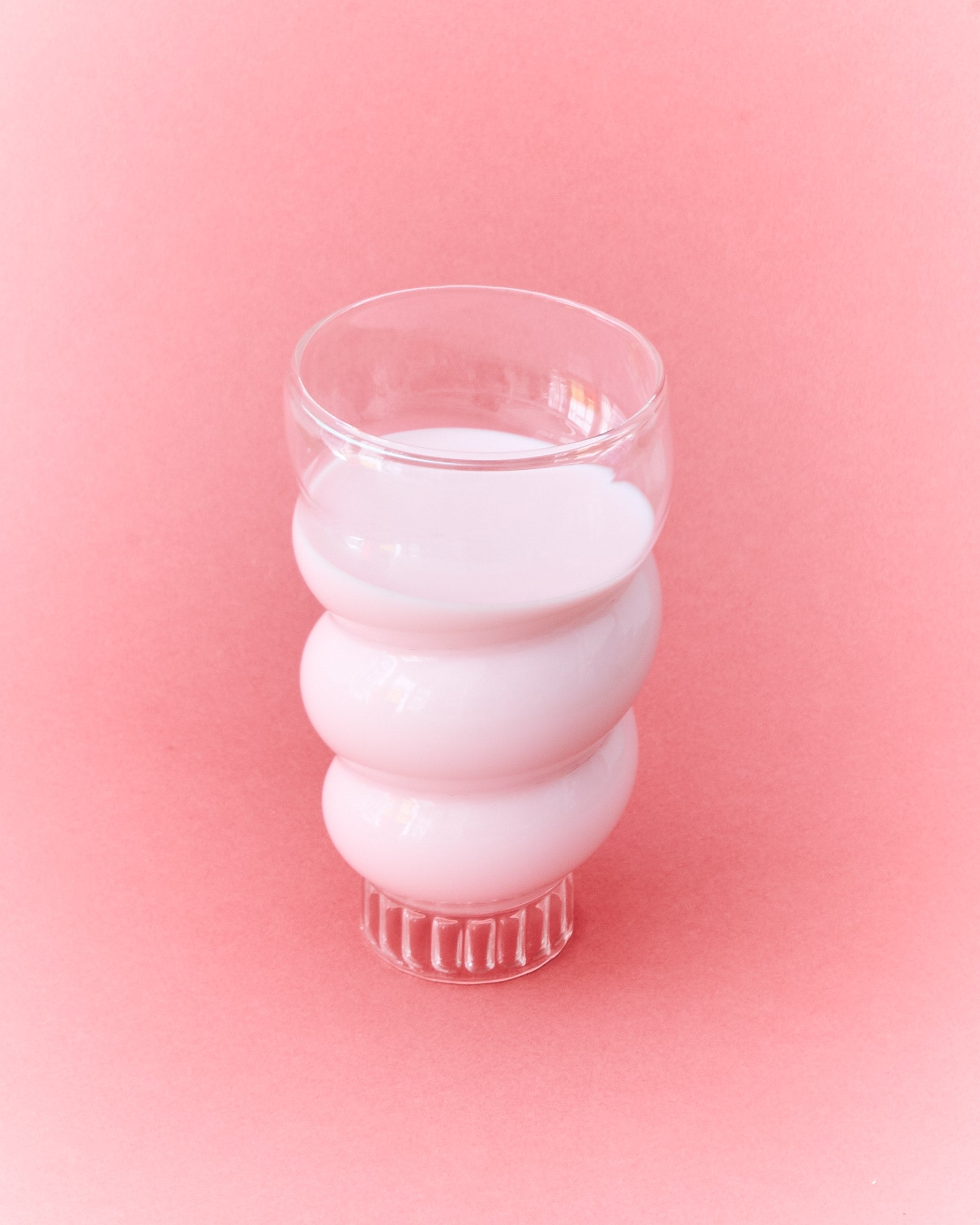 Stacked Paguro ribbed glasses in translucent white glass detail