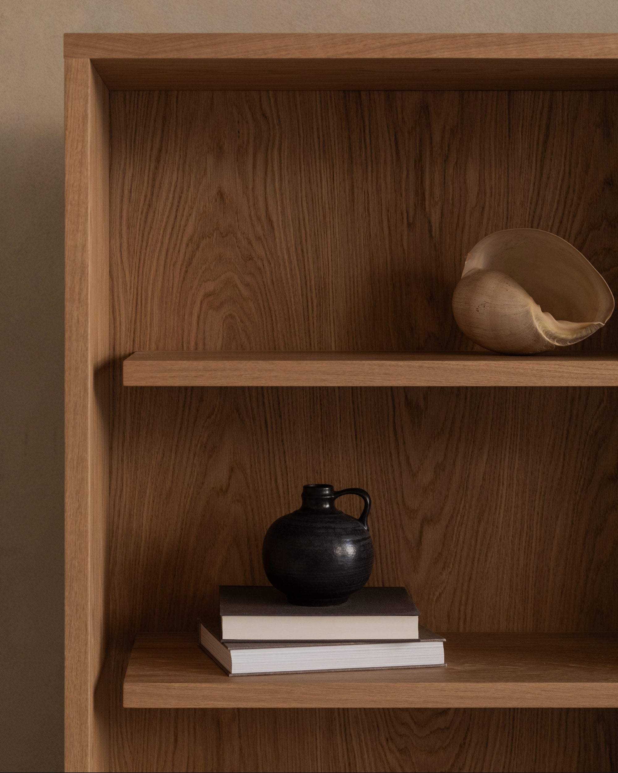 BLOCK oak cabinet interior detail showing styled shelves with ceramic vessels and books
