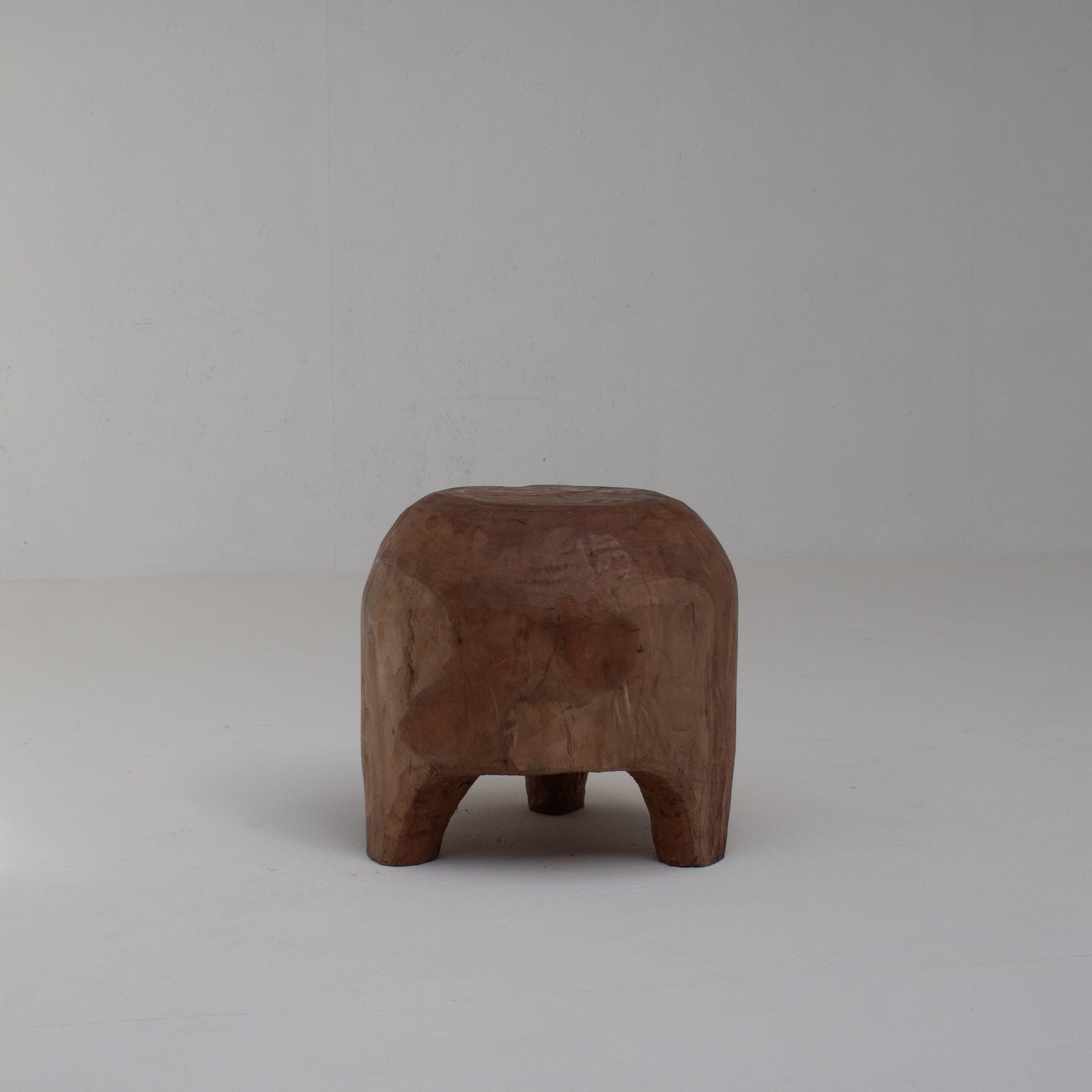 Sculptural Solid Wood Stool in Warm Natural Patina — detail view