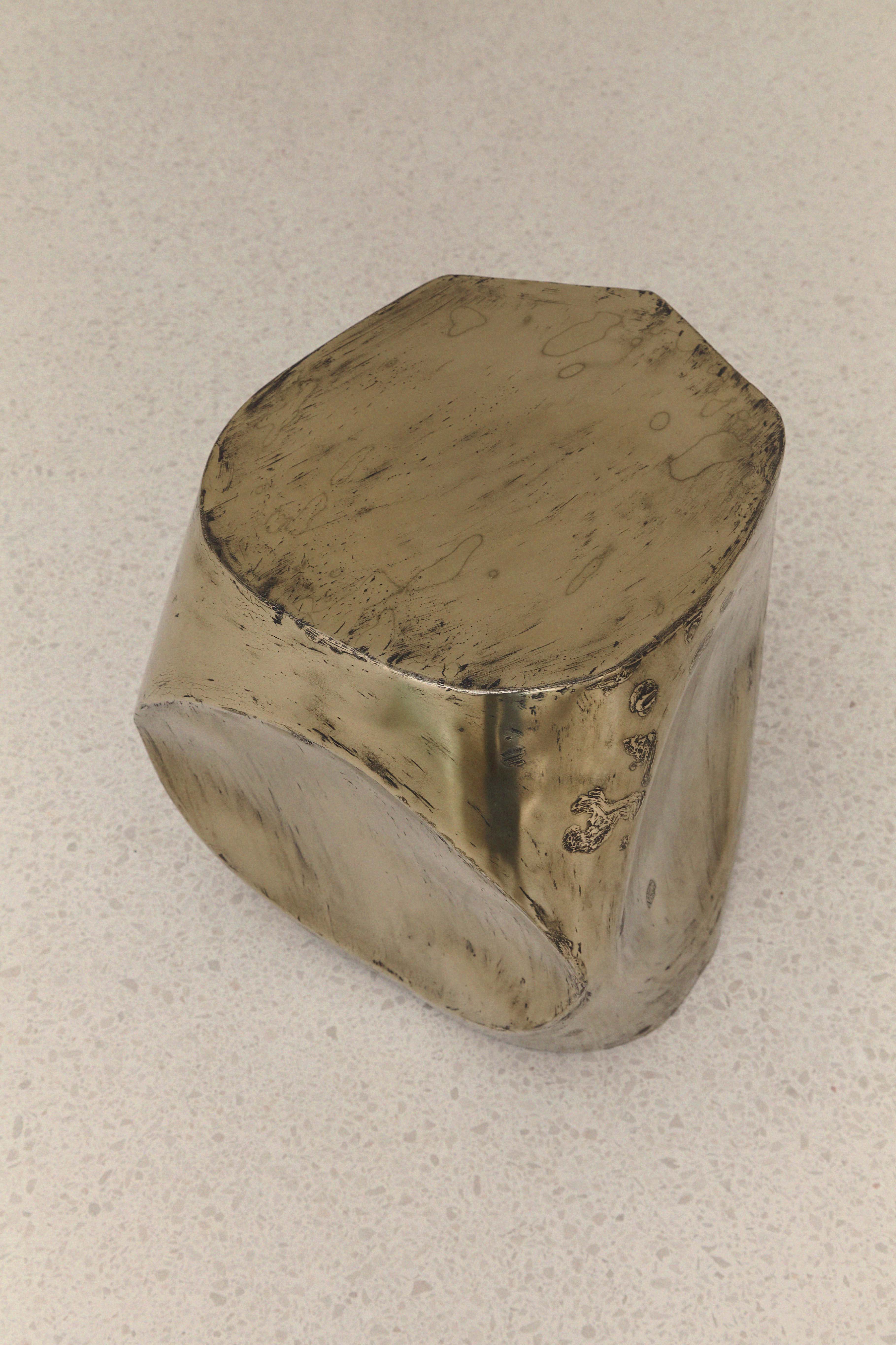 ROCHER SMALL TABLE IN POLISHED BRASS RESIN — angled view on light countertop