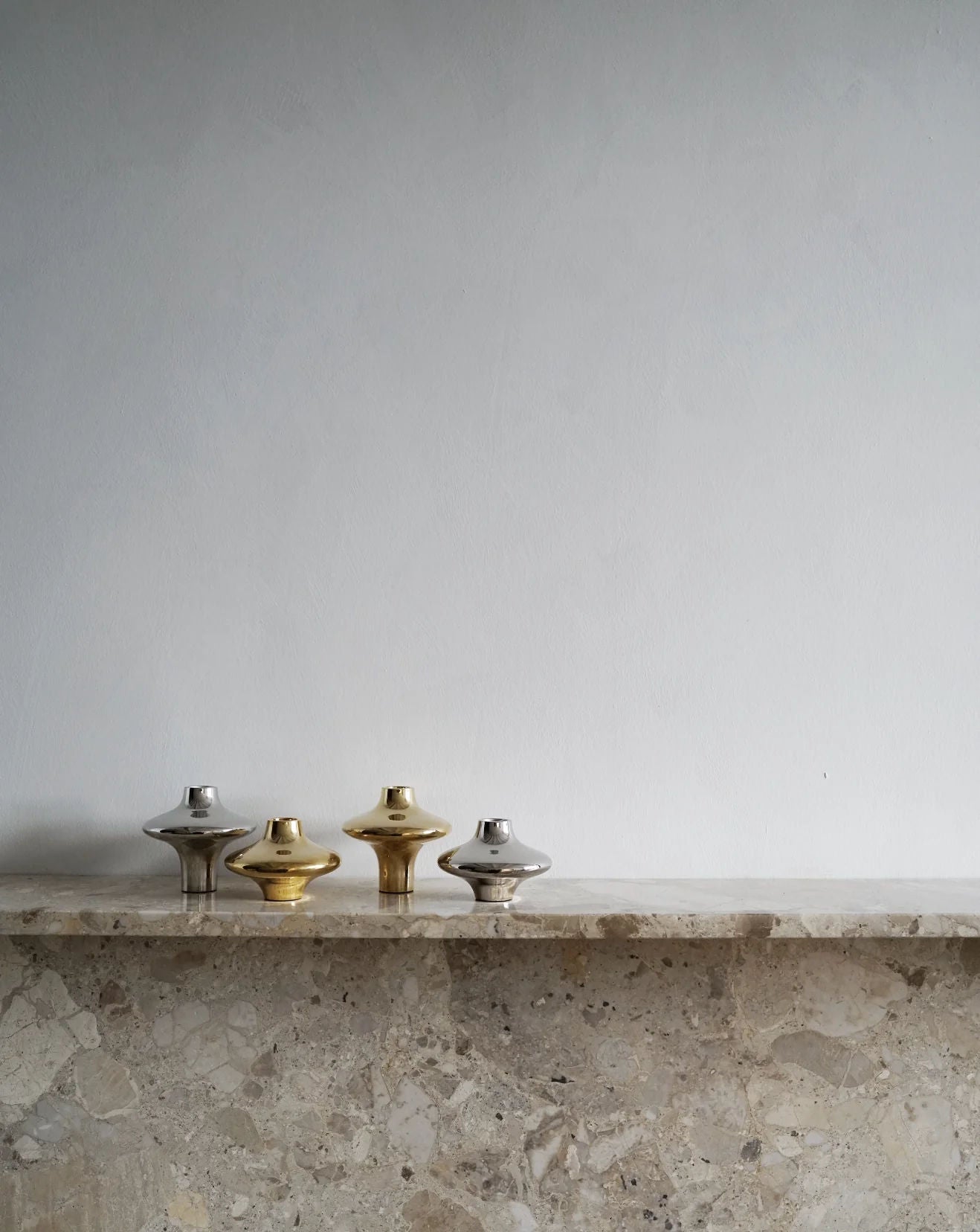 Doublet Candleholder - Small - Silver — displayed on stone shelf against white wall