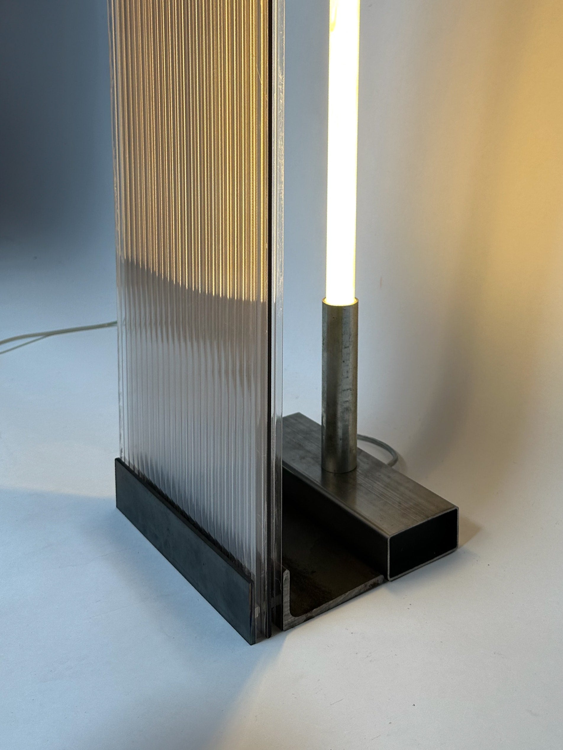 POLY-C-1 extra tall - smoke — close-up of textured acrylic and metal base