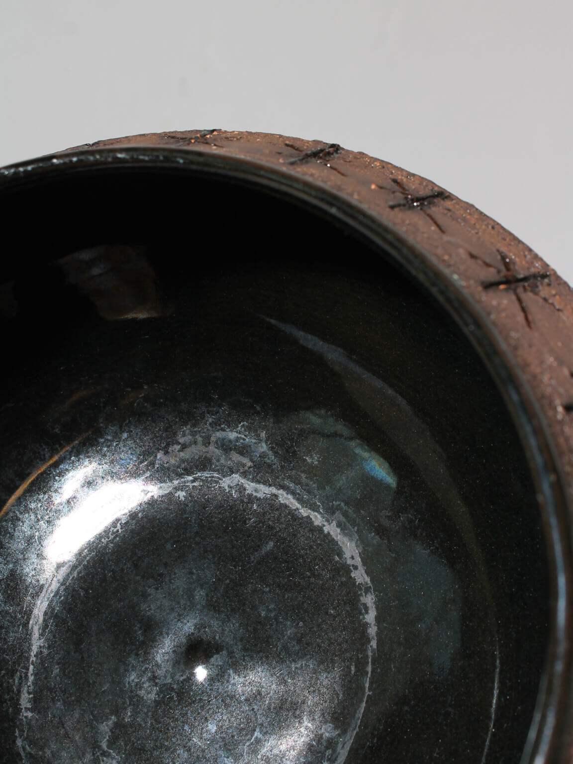 Eke Bjerén Swedish Ceramic Bowl On Legs — top view of dark ceramic interior