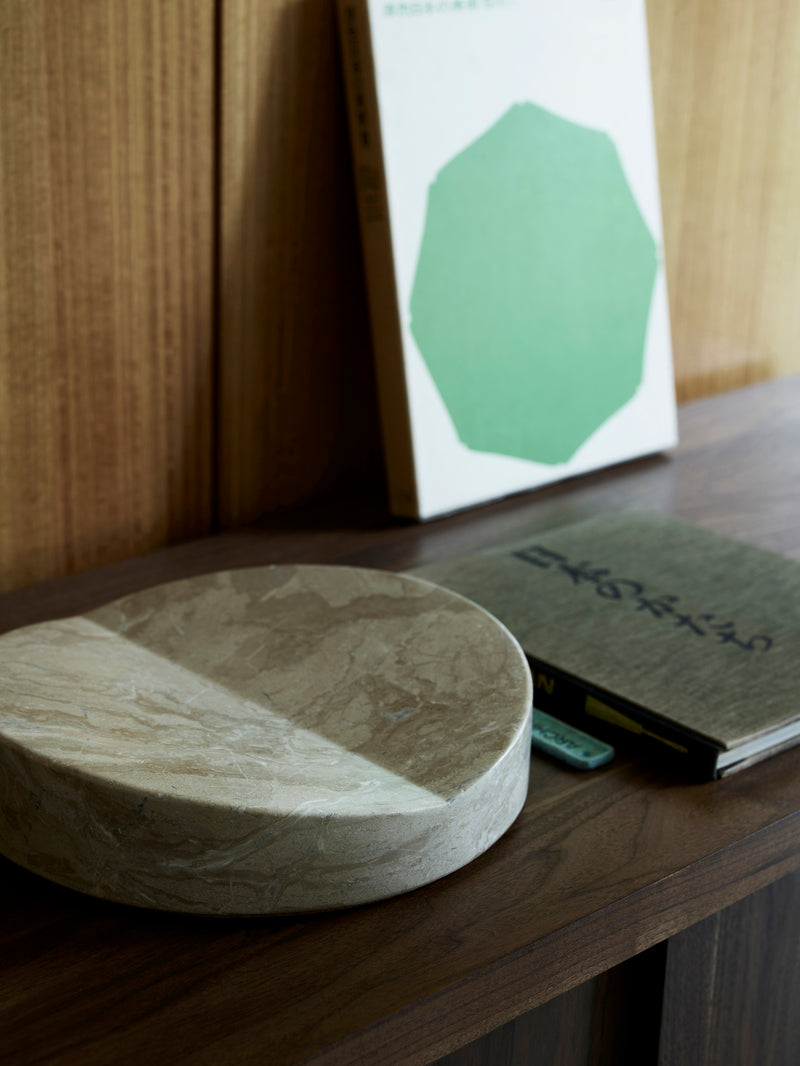 Fane marble bookstand lifestyle setting on wooden surface with book