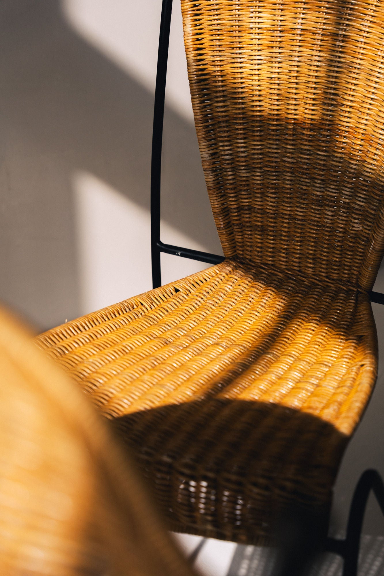 Close-up of woven wicker seat detail on 1950s Frederic Weinberg chair