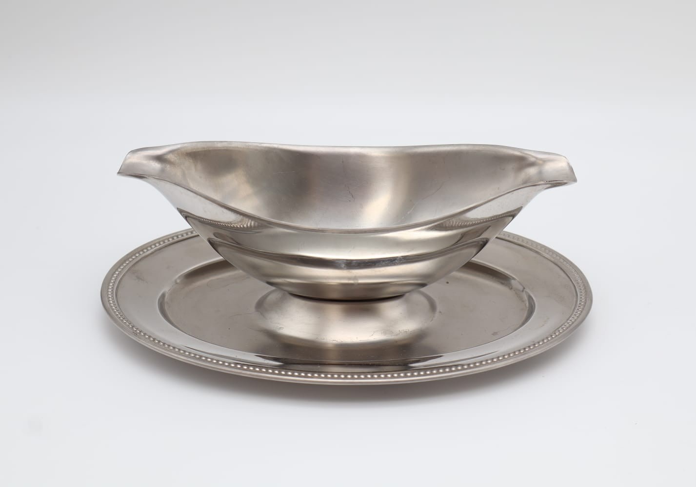 Vintage Guy Degrenne Stainless Steel Gravy Boat with Fixed Saucer (c. 1970) — detail view