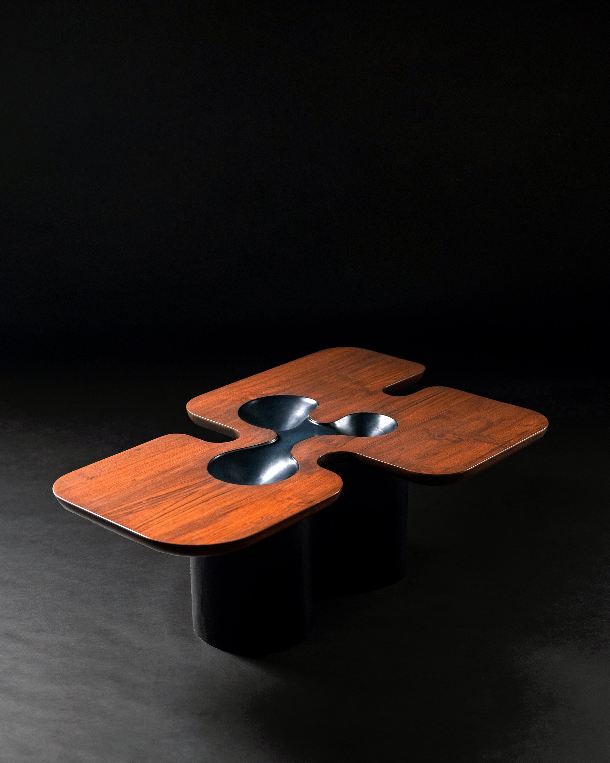 Canyon Centre Table — close-up of dark wood surface with cutouts