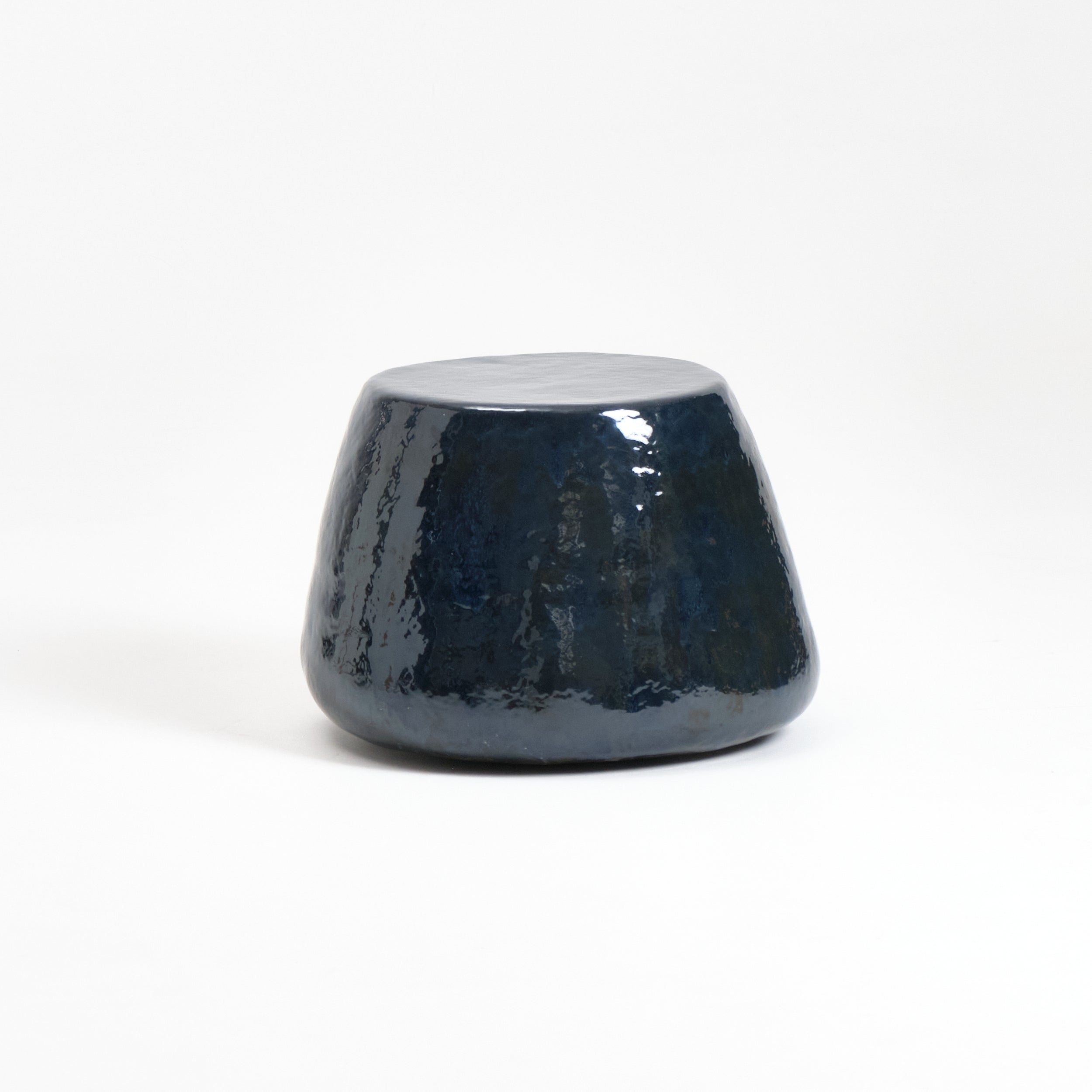 Medium Ceramic Side Table — angled view of glossy navy finish