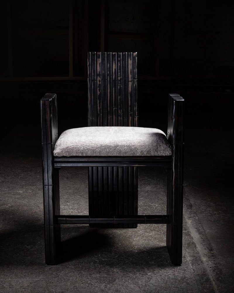 Modern dark wood armchair with upholstered seat and vertical slat back