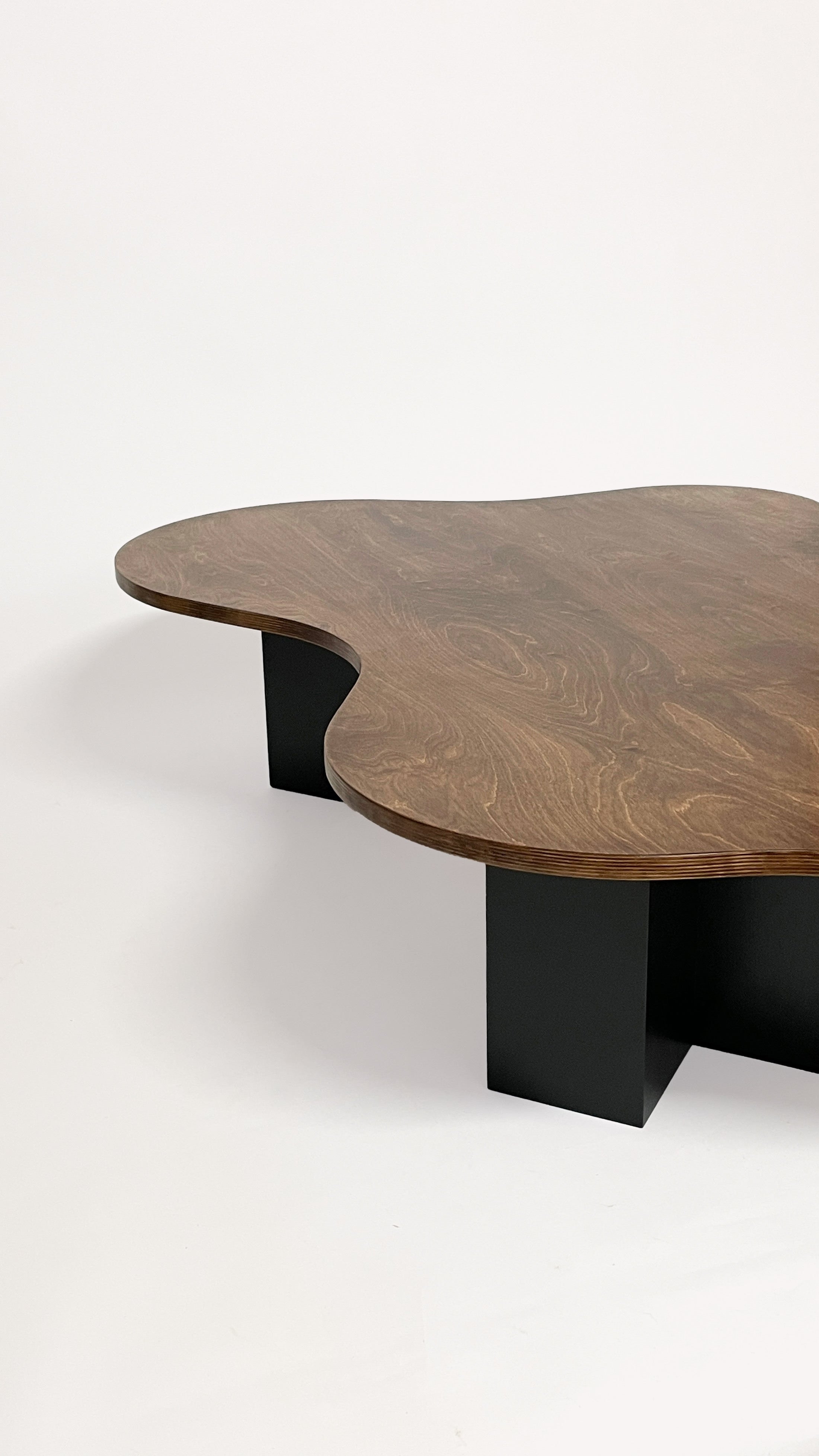 Spill Table - Oak Black by Goons — angled view of wooden tabletop with black legs