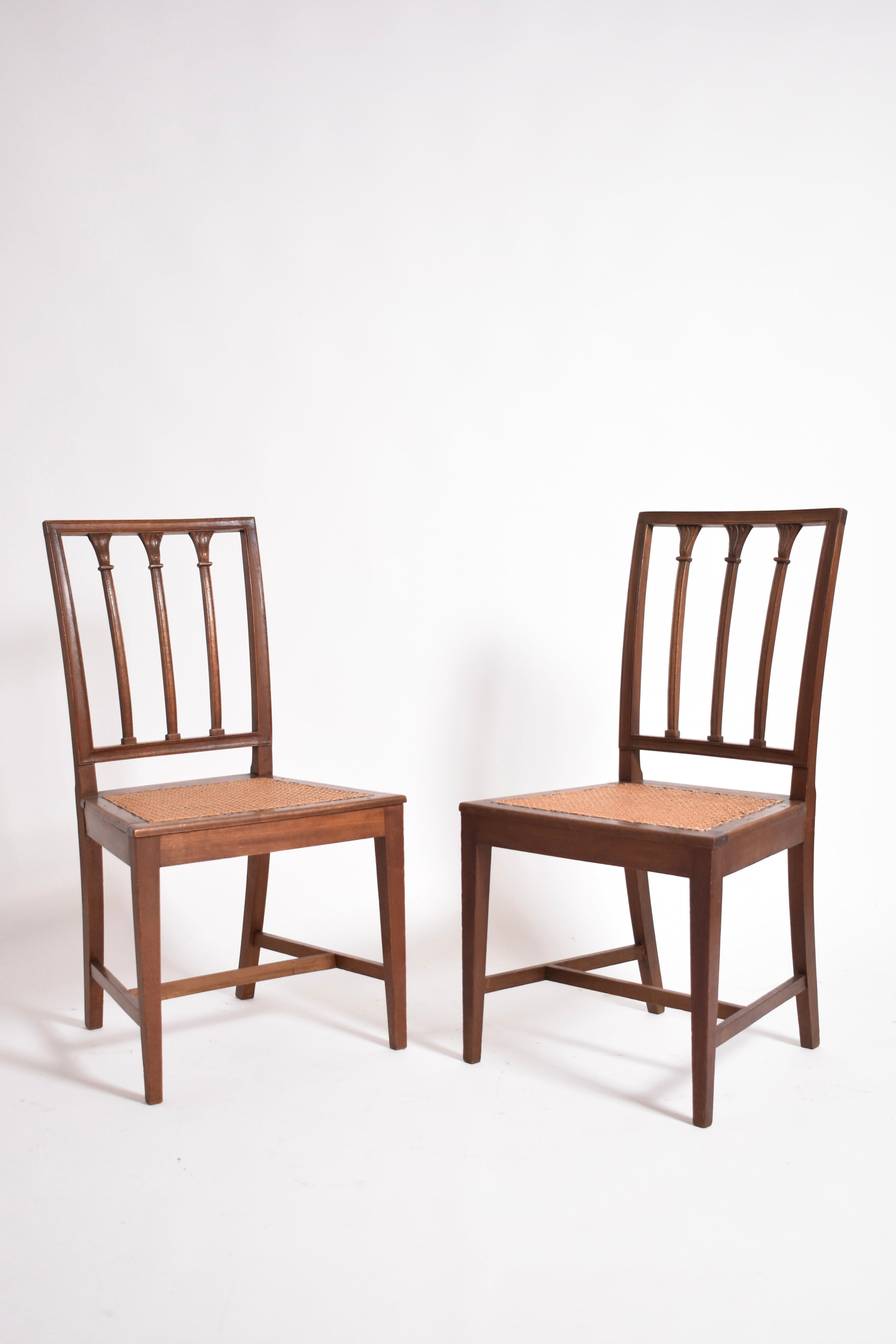 The Barracuda Interiors Pair of Dona Maria Chairs, 19th c, features vertical slat backs and woven cane seats, shown side by side against a plain white background.