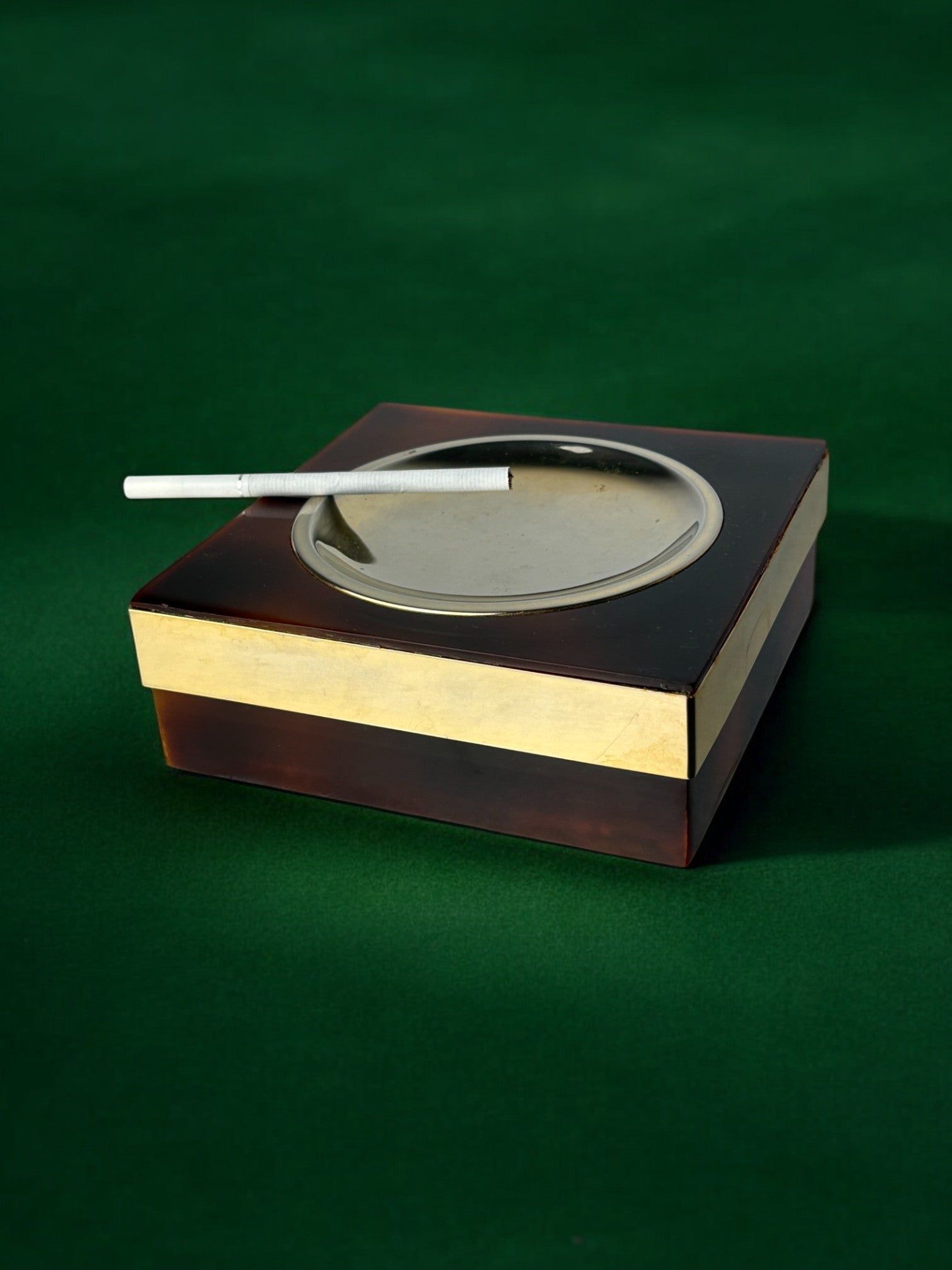 Faux Tortoise Shell Ashtray, Italy, 1970s — side angle with silver rim and cigarette