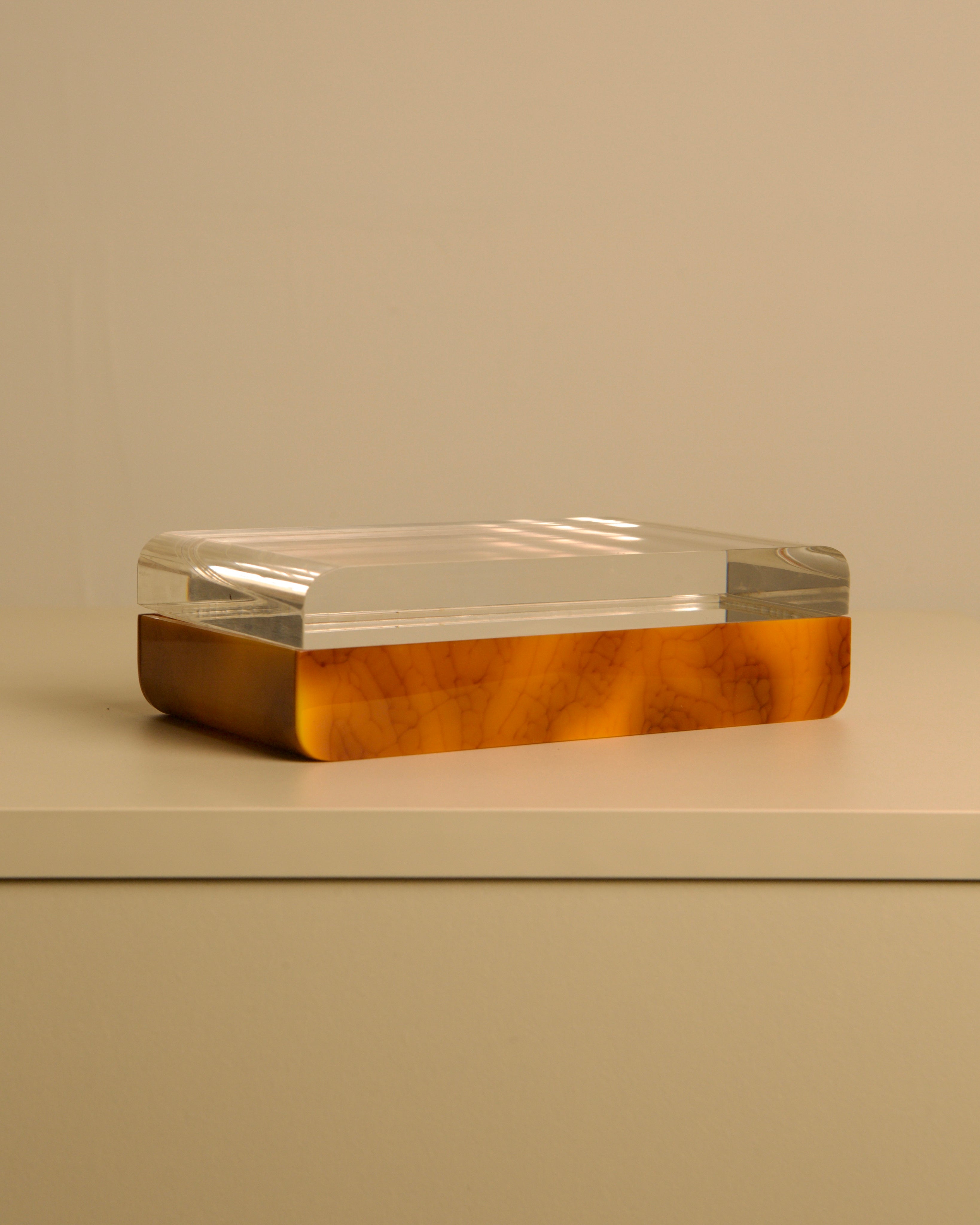 Italian box in plexiglass and brown bakelite, 70s — close-up of brown bakelite base