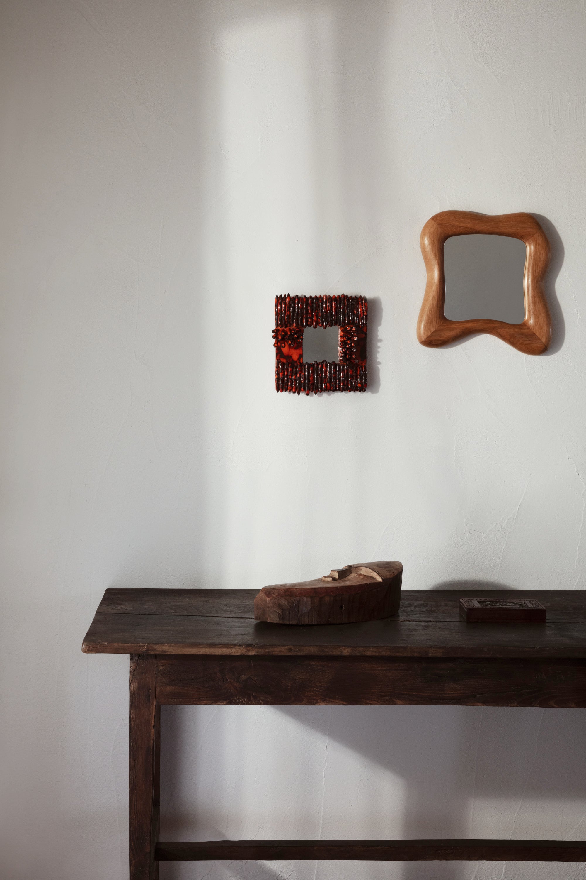 Dedo' Ceramic Mirror — close-up of mirror frame against textured wall